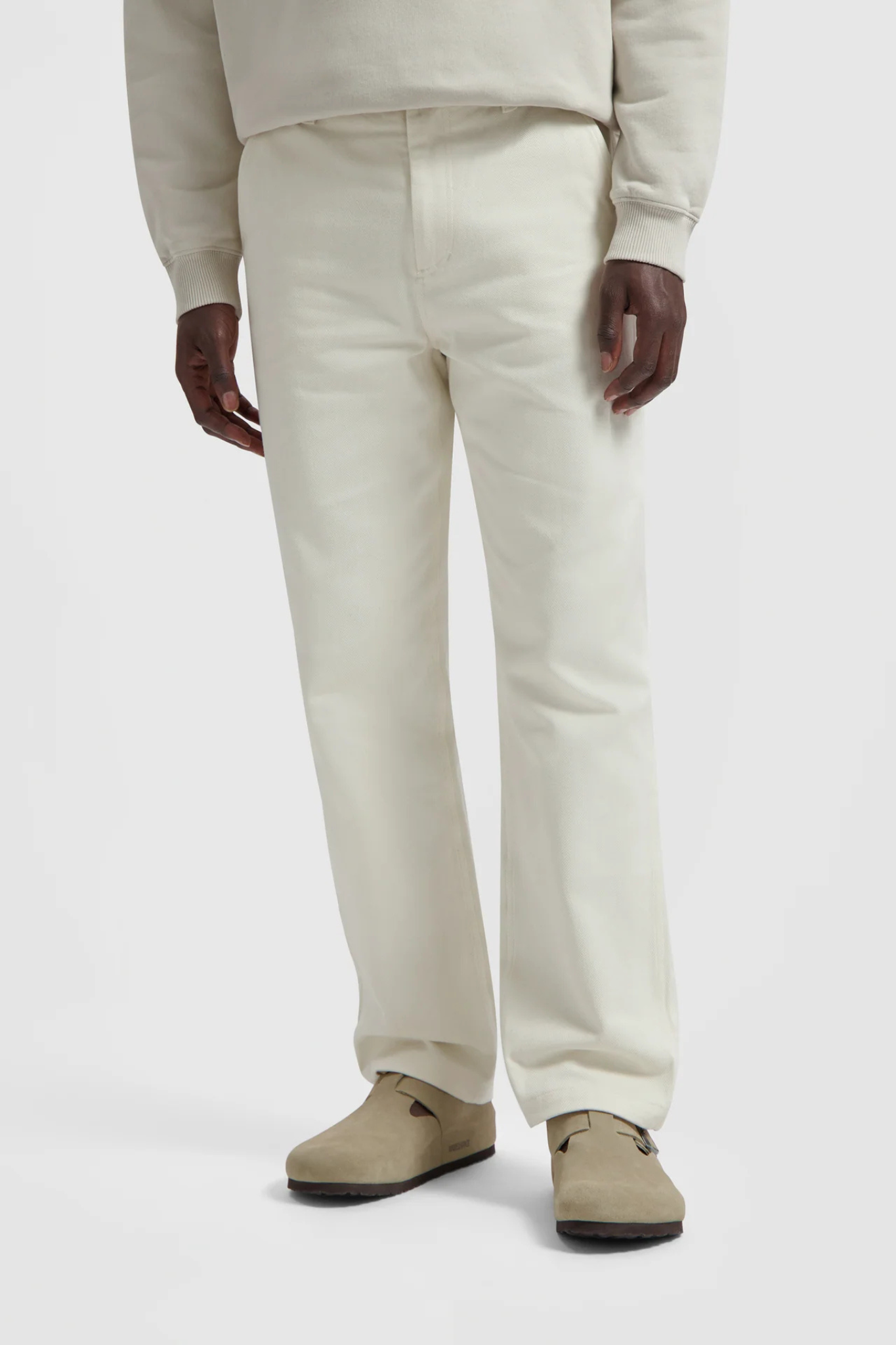 Model wearing the Olaf workwear pants in off-white. Front view