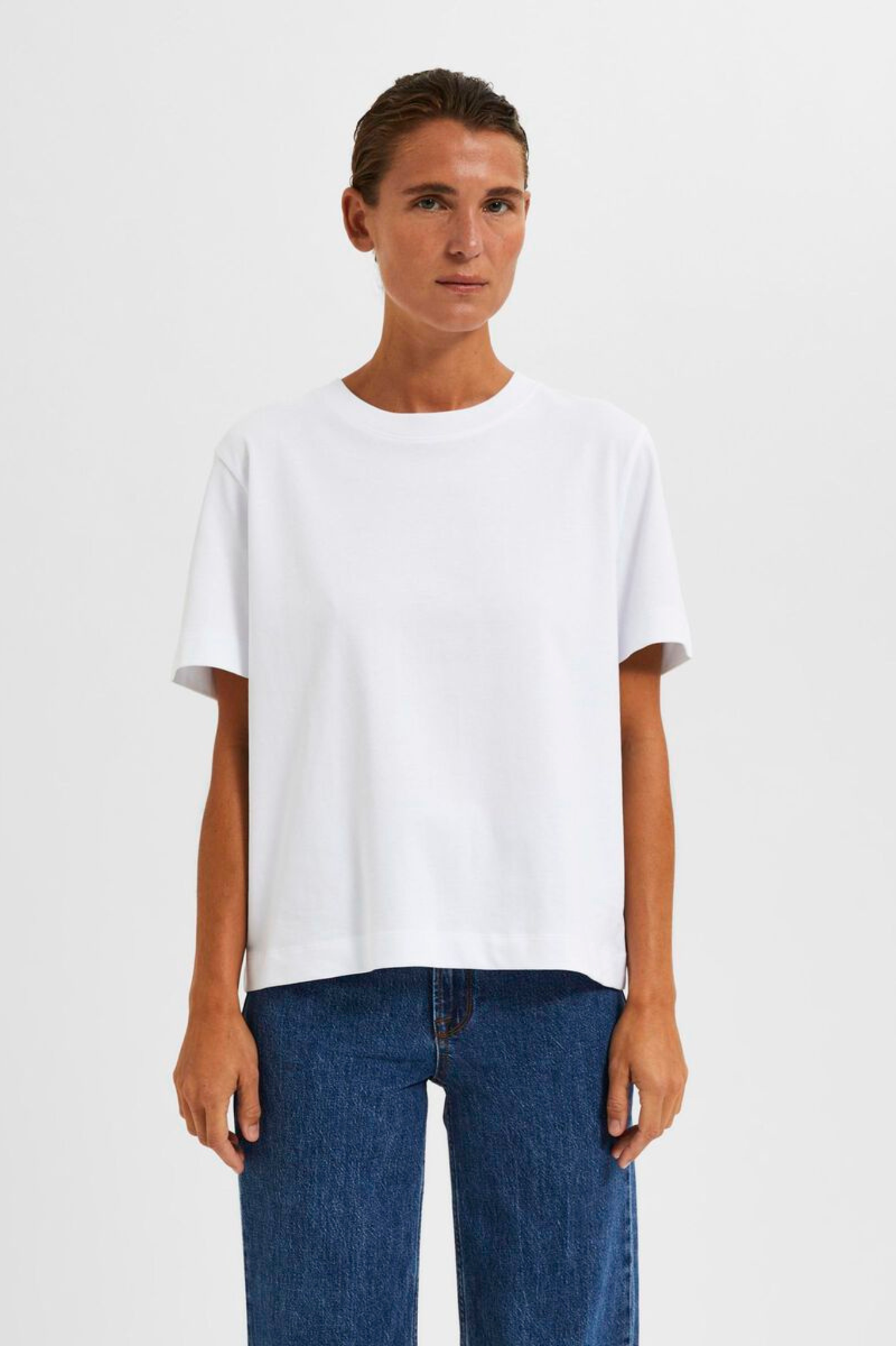 Model wearing the Selected Femme white boxy t-shirt. Front view