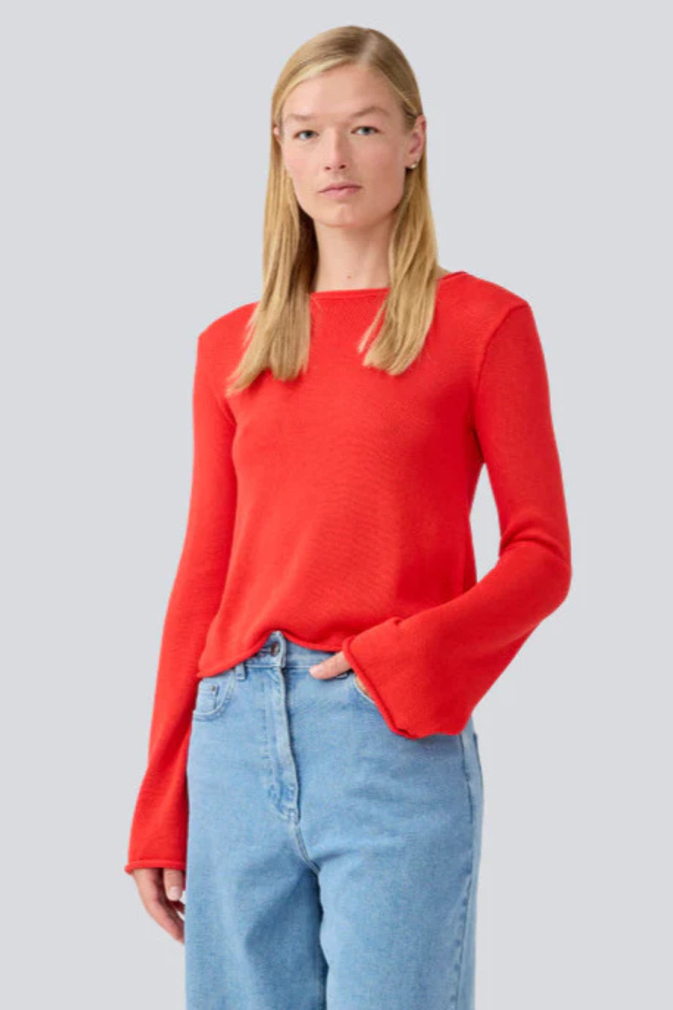 Model wearing the Modstrom ivonne flared o neck top in red. Front view