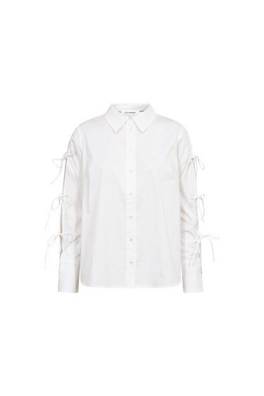 Co'Couture white shirt with bows on sleeve. Front flatlay view