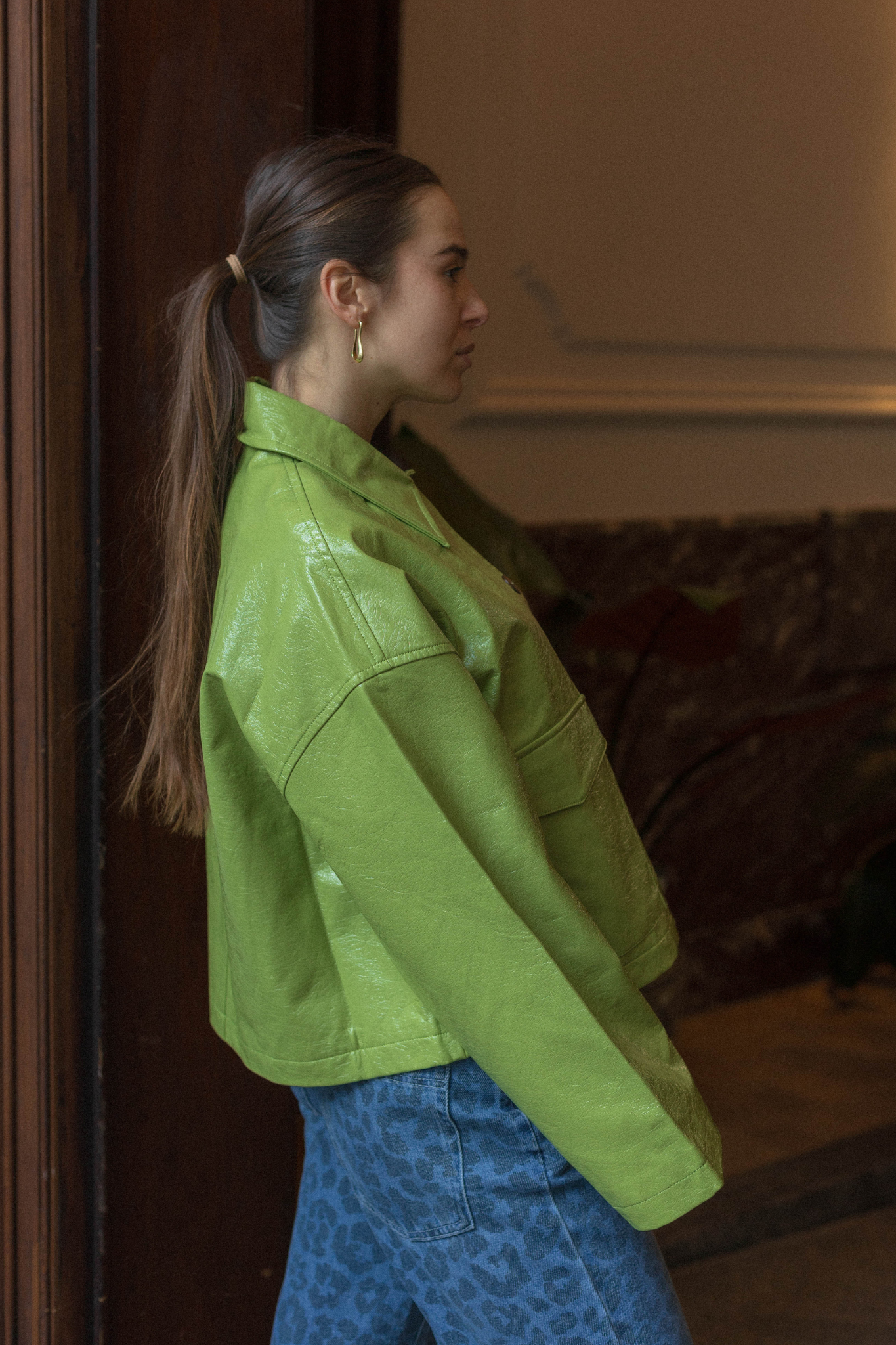 Model wearing the FRNCH carmelie jacket in green. Side view