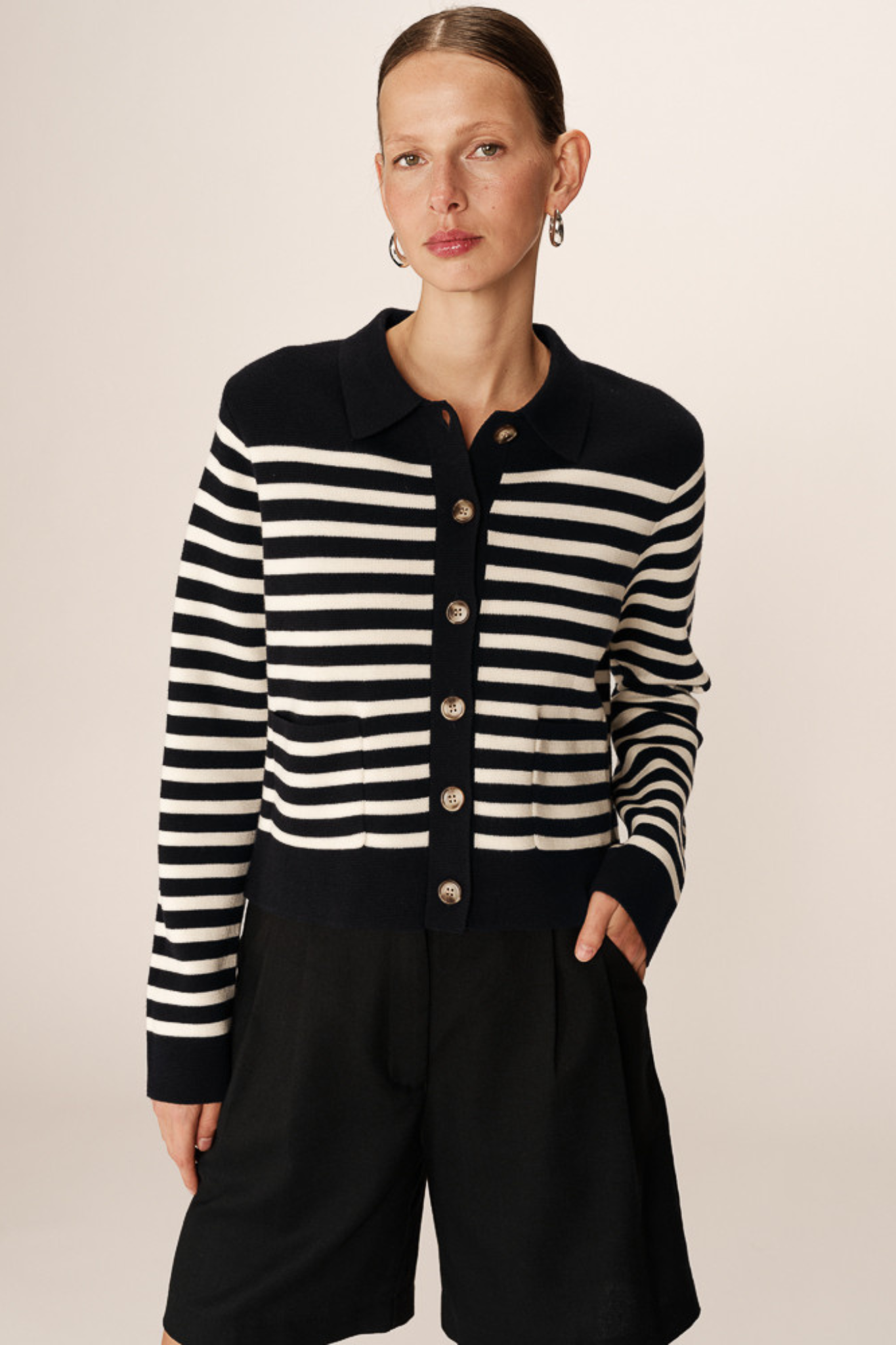 Model wearing the Grace & Mila pam cardigan in marine stripes in black and white. Front view