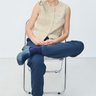 Model wearing the American Vintage beige sleeveless cardigan with logo in blue. Front view