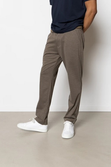 Model wearing the Clean Cut Copenhagen jersey pants in dark khaki. Front view