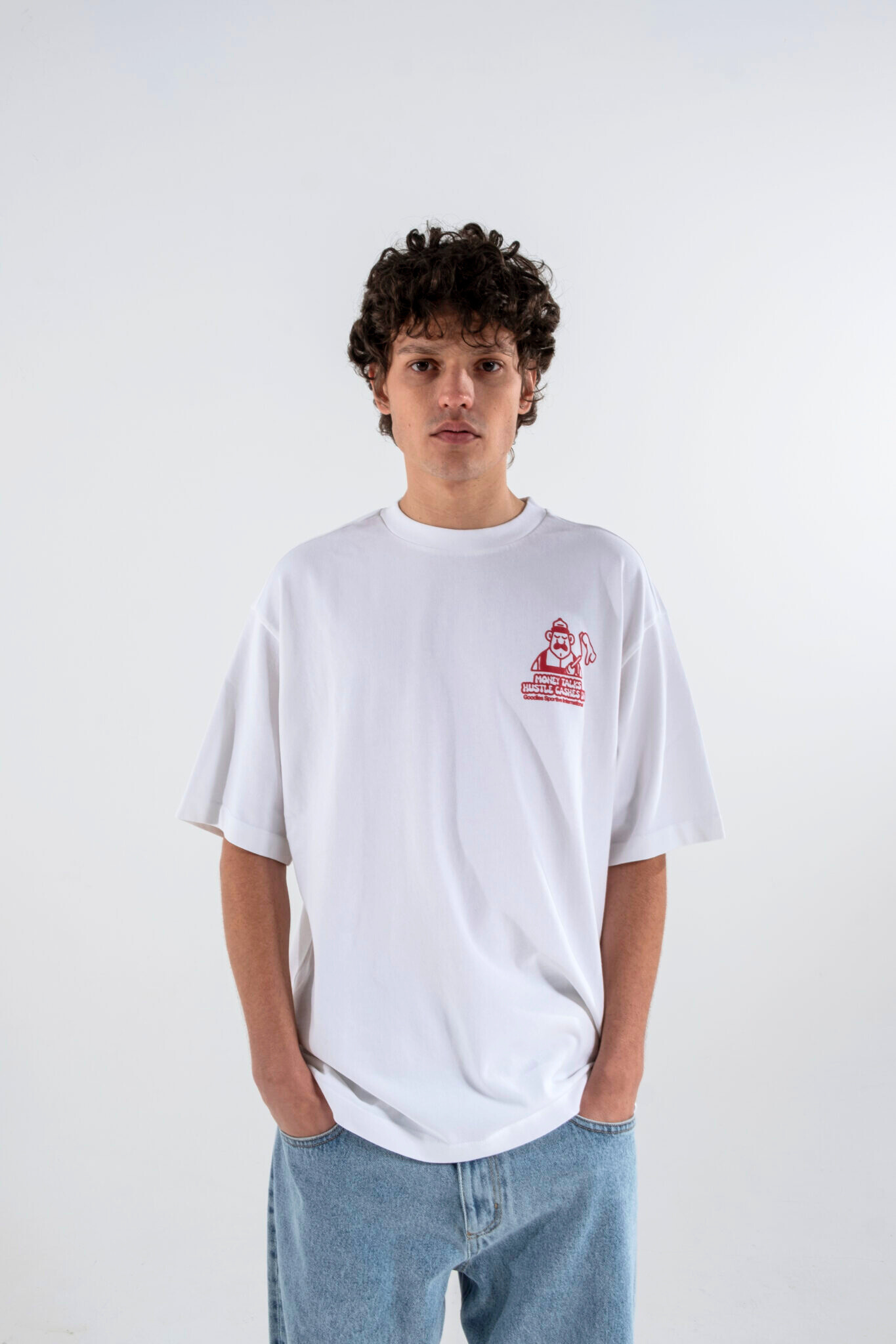 Model wearing the Goodies Sportive money talks t-shirt in white and graphic in red. Front view