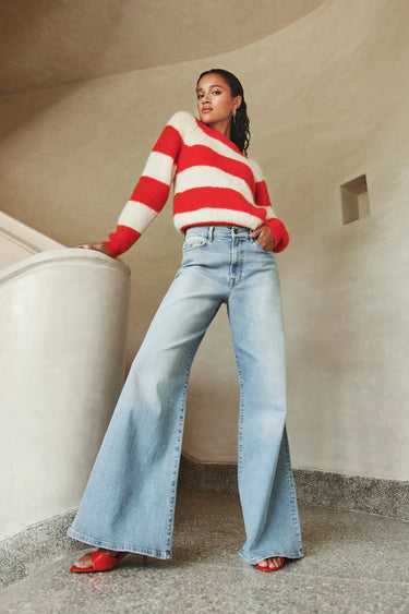 Model wearing the By-Bar Sian striped pullover in red and white. Front view