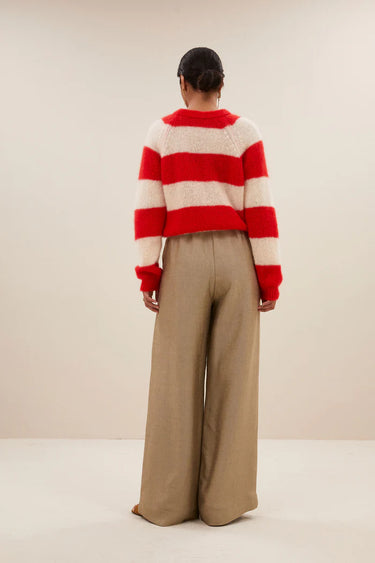 Model wearing the By-Bar Sian striped pullover in red and white. Back view