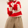 Model wearing the By-Bar Sian striped pullover in red and white. Front view