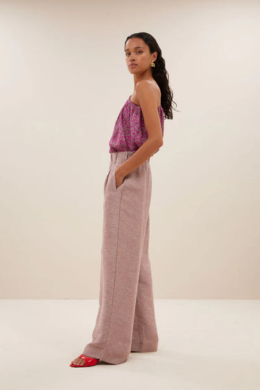 Model wearing the By-Bar Benji gloss pants in mellow rose. Side view