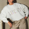 Model wearing the By-Bar bibi lucky rainbow sweater in grey. Front view