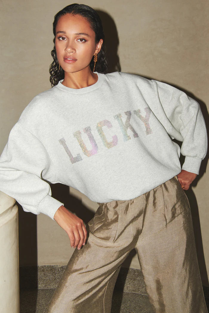 Model wearing the By-Bar bibi lucky rainbow sweater in grey. Front view