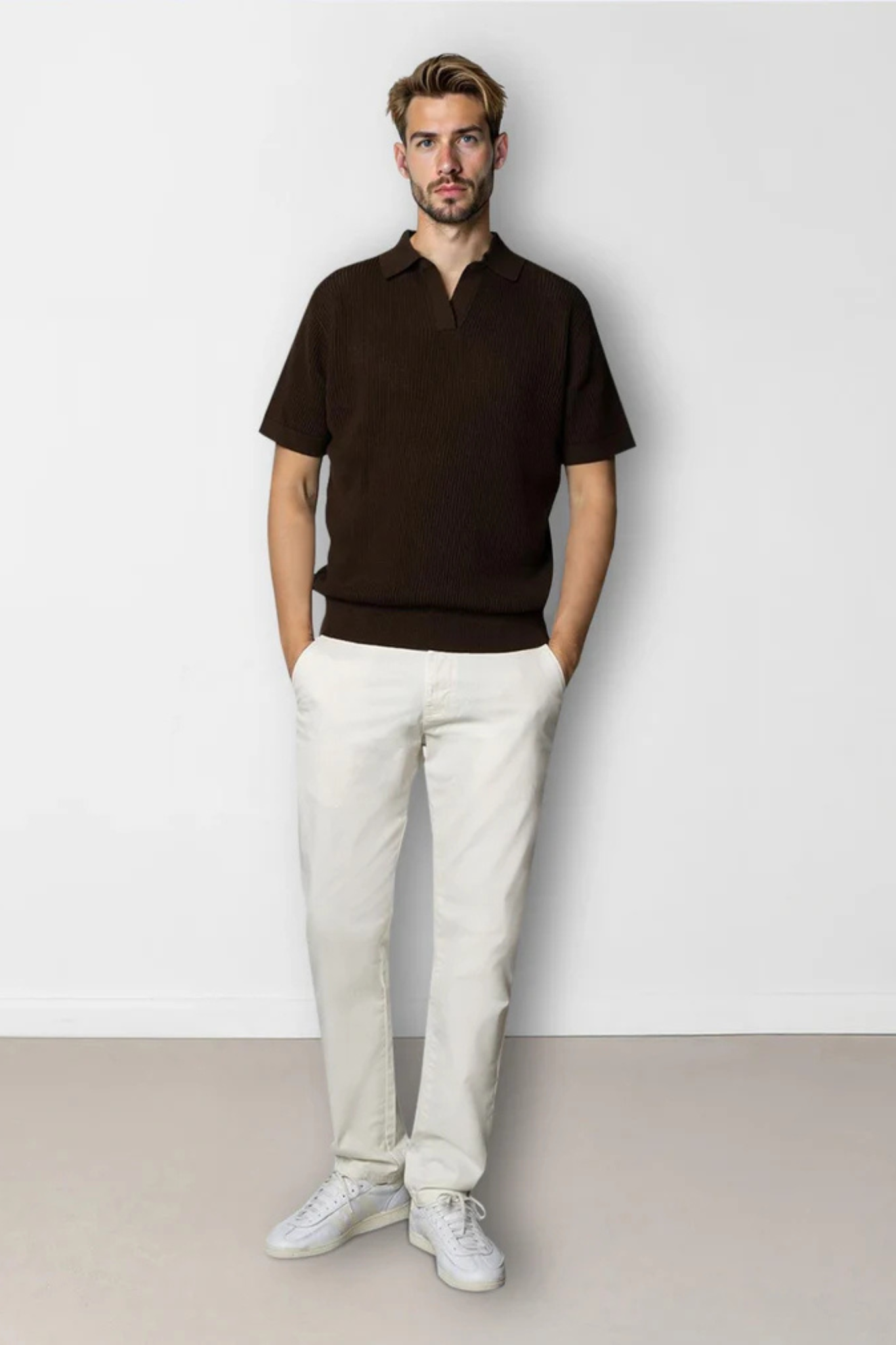 Model wearing the Clean Cut Copenhagen  oliver knitted polo in dark brown. Front view