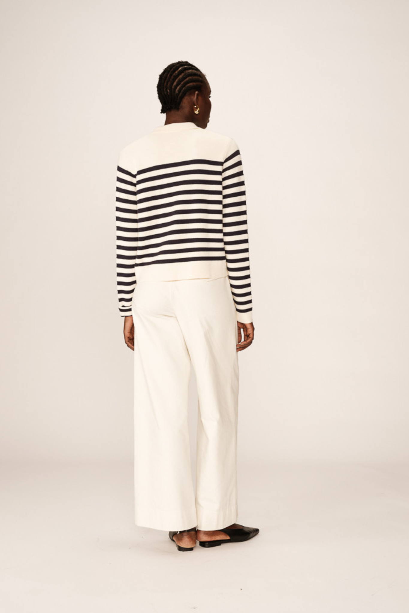 Model wearing the Grace & Mila pam cardigan in marine stripes in ecru and navy. Back view