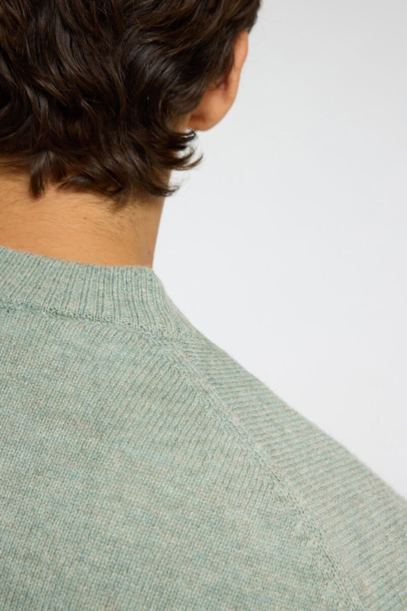 Model wearing the Selected Homme reuben ls knit relaxed crewneck in green. Close back view