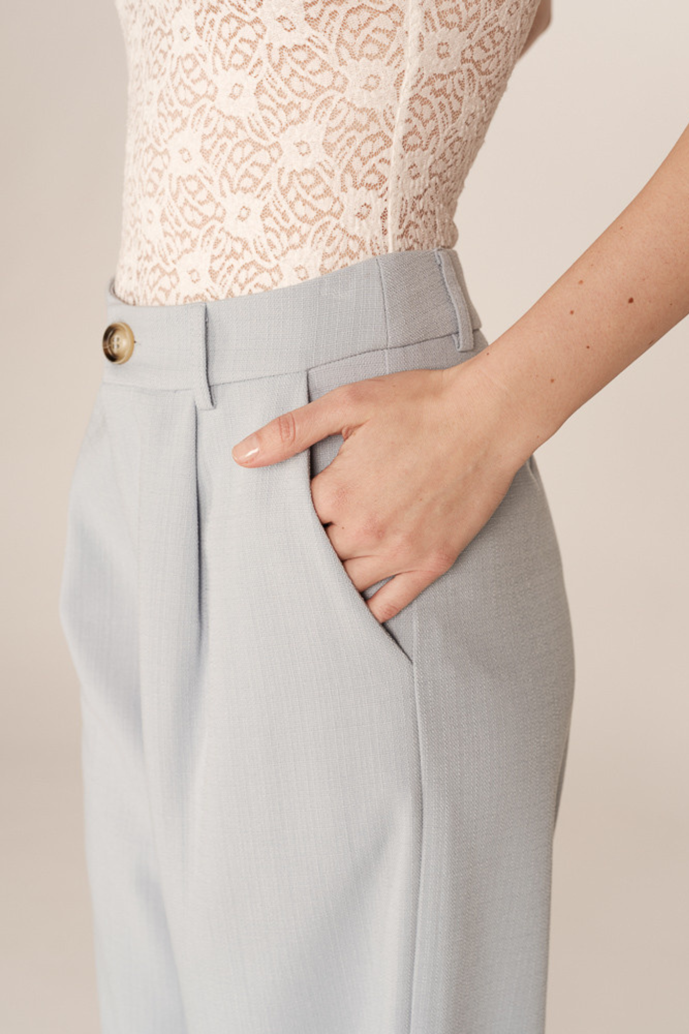 Model wearing the Grace & Mila pierre pants in light blue. Close pocket view