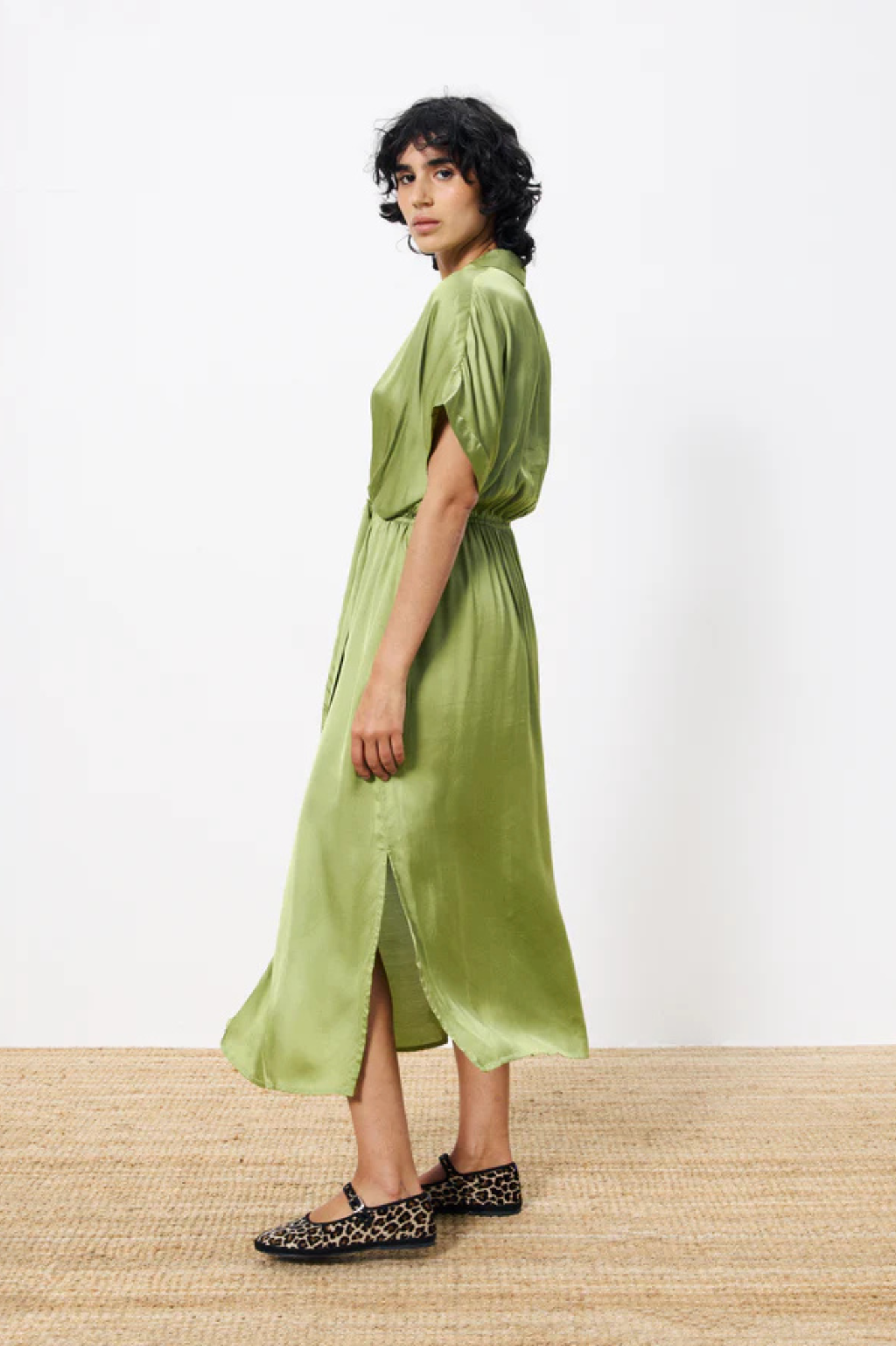 Model wearing the FRNCH estee dress in green. Side view