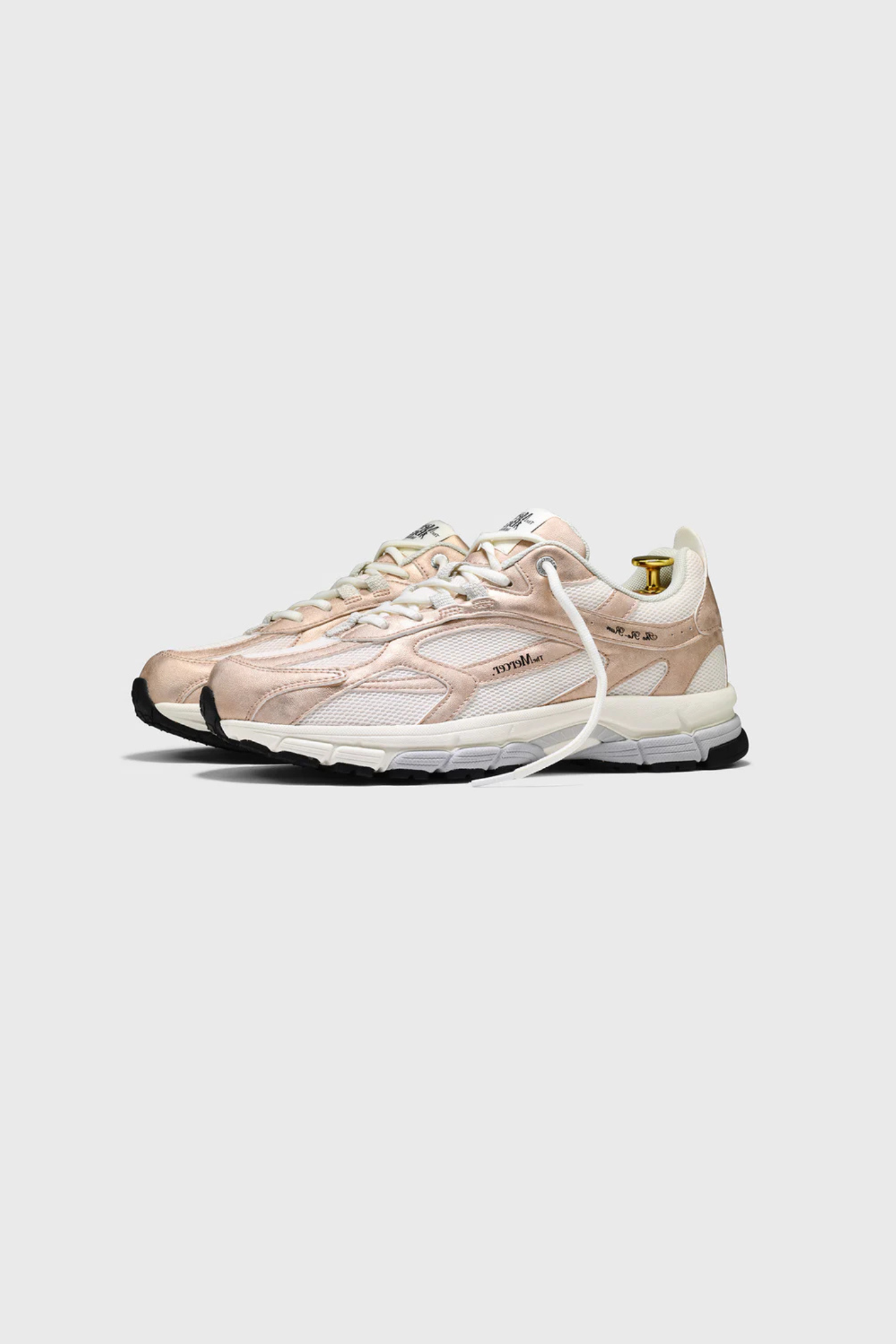 Mercer re-run metallic sneakers in white and pink. Side view