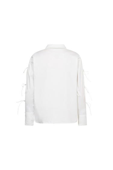 Co'Couture white shirt with bows on sleeve. Back flatlay view