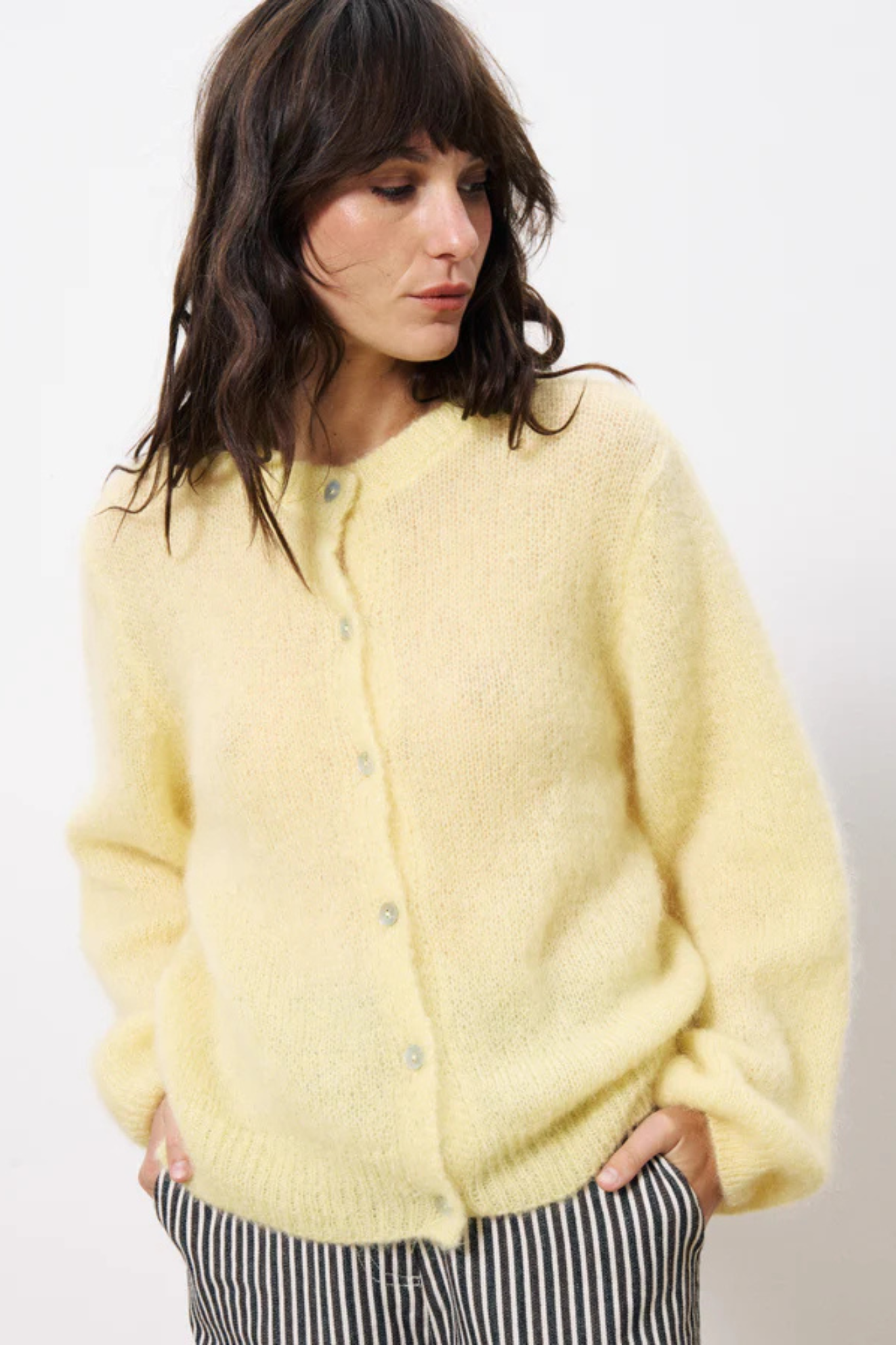 Model wearing the FRNCH calixta cardigan in butter/yellow. Front view