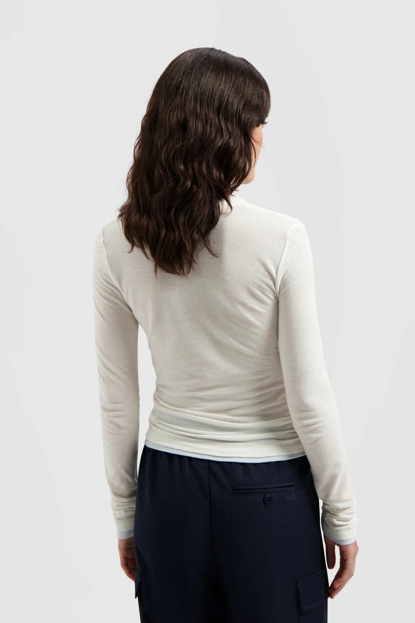 Model wearing the Olaf retro logo double layer top in white. Back view