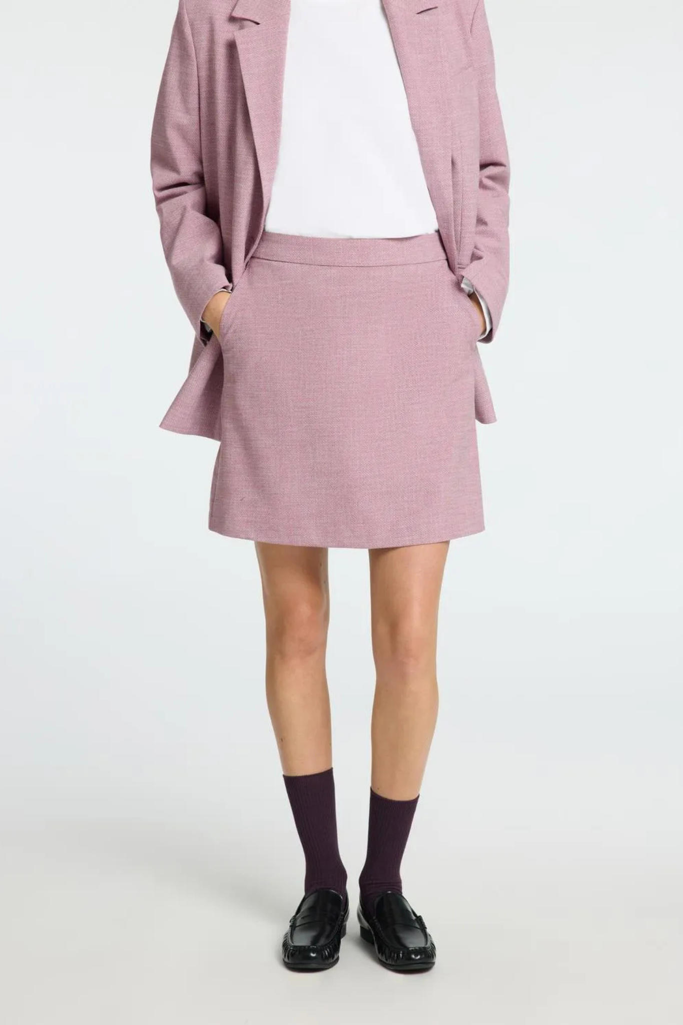 Model wearing the Selected Femme mini skirt in mauve. Front view