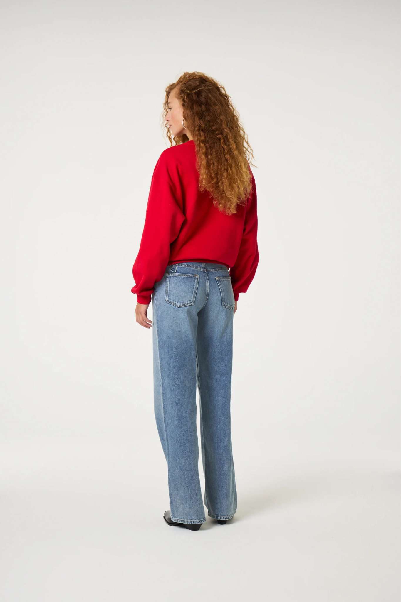 Model wearing the Fabienne Chapot Terry chili sweater in red. Back view