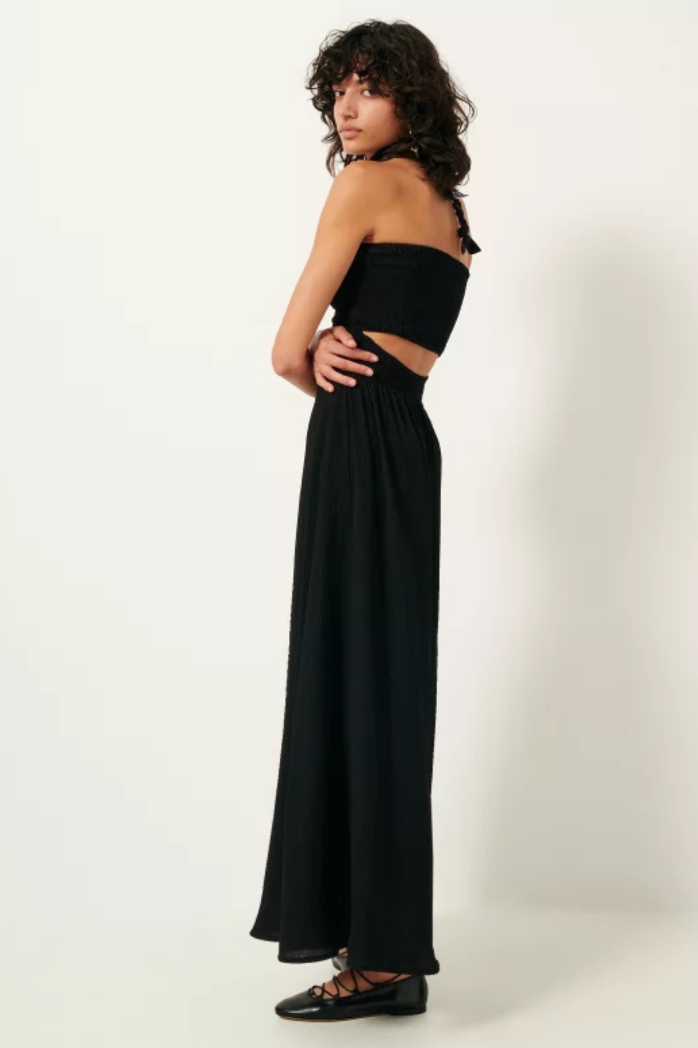 Model wearing the Sessun millie dress in black. Side view