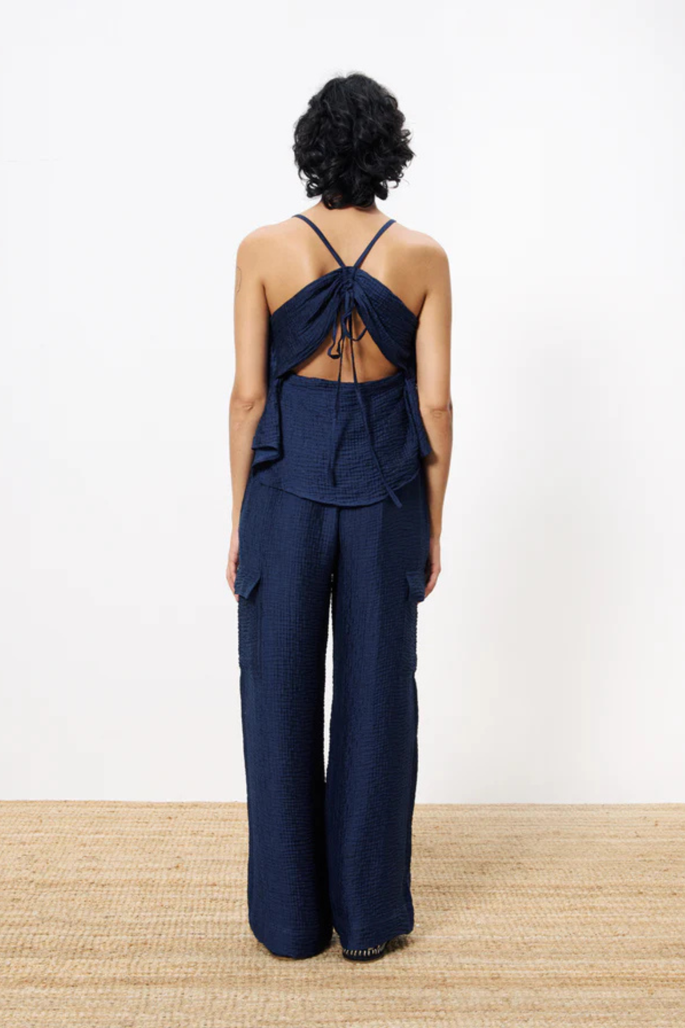 Model wearing the FRNCH loreen pants in blue marine. Back view