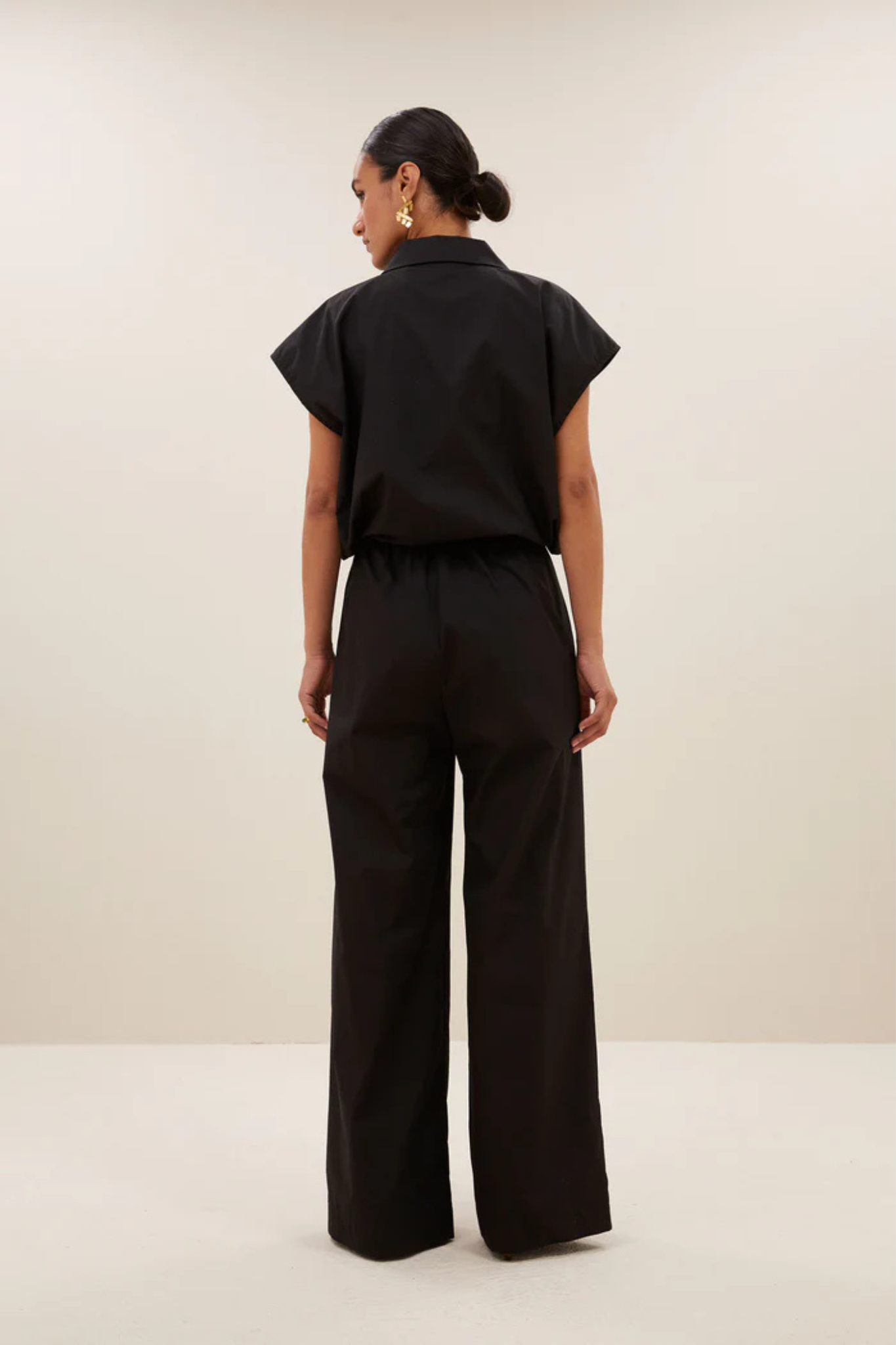 Model wearing the By-Bar bieke poplin blouse in black. Back view