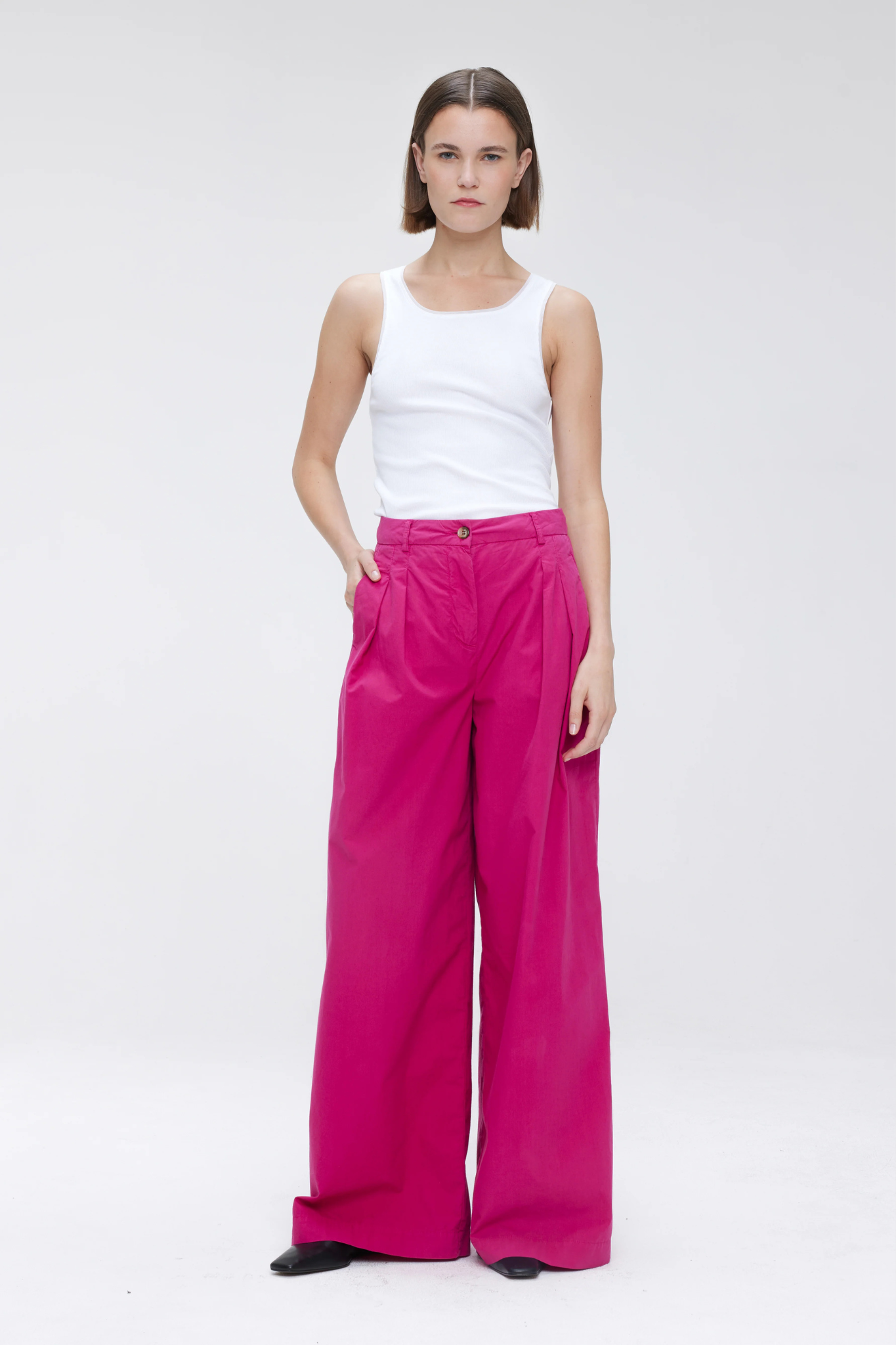 Model wearing the Our Sister Pansmokeyc pants in fuchsia. Front view