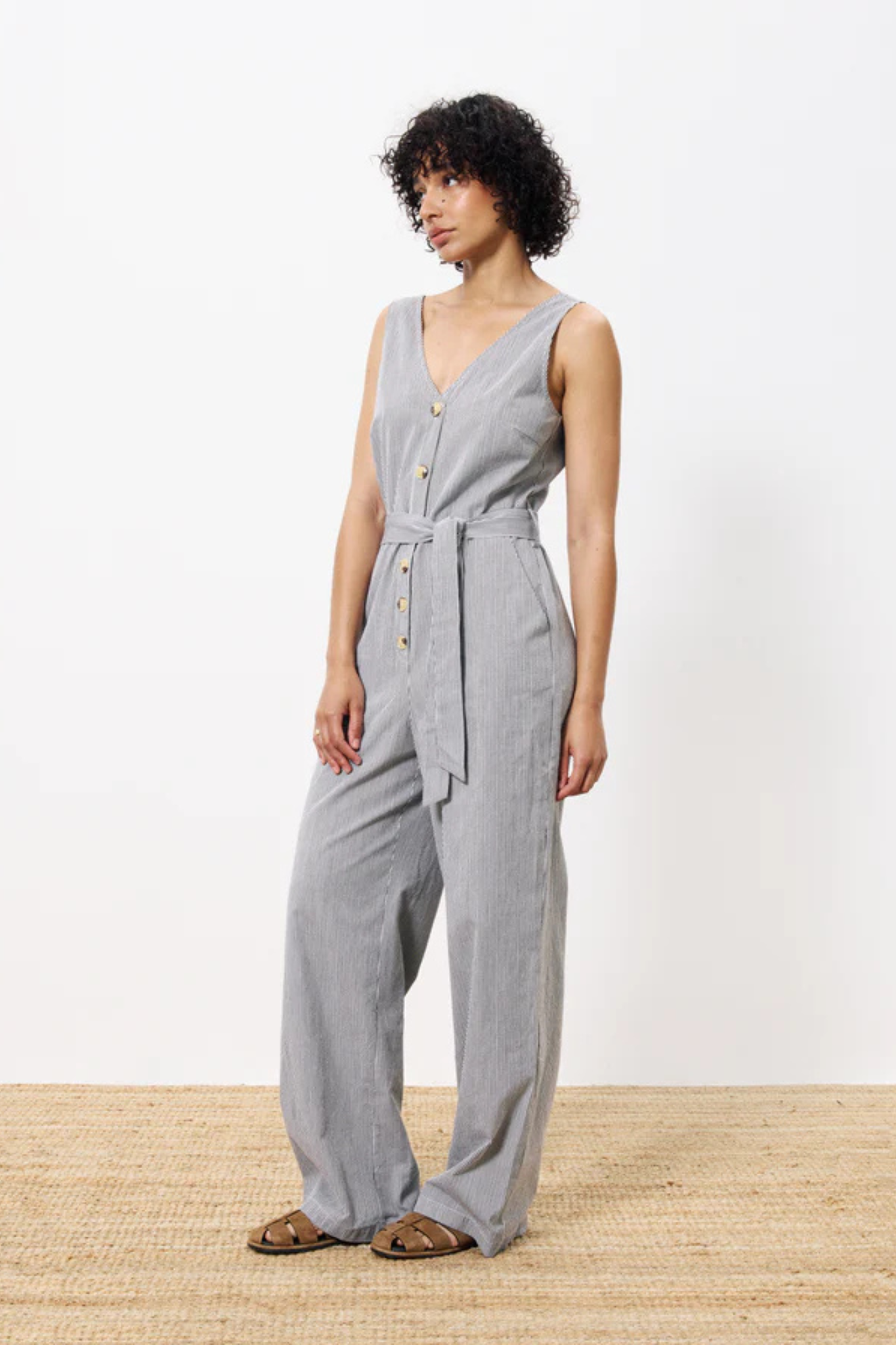 Model wearing the FRNCH maddie jumpsuit in creme. Side view