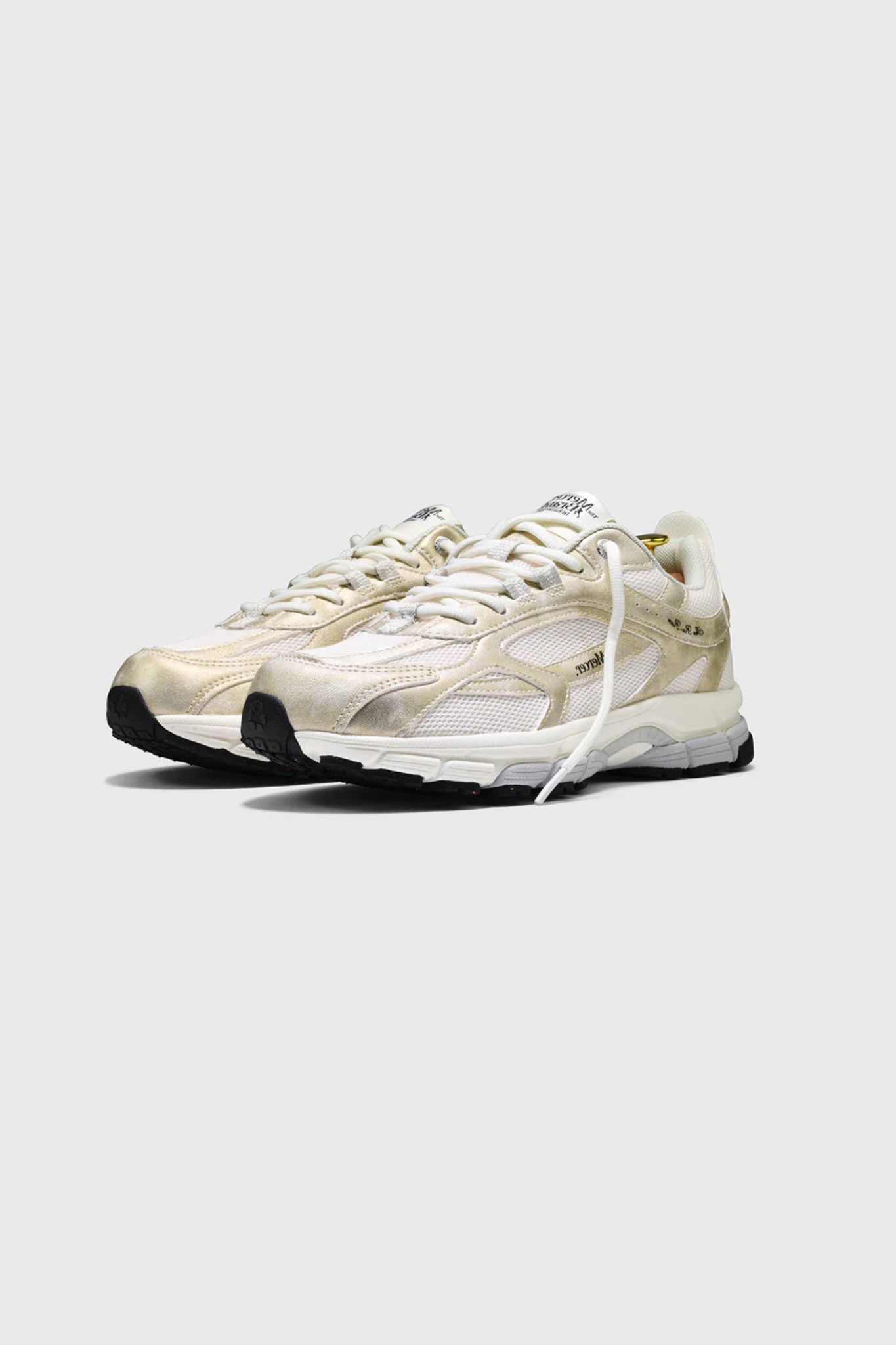 Mercer re-run metallic sneakers in gold. Side view