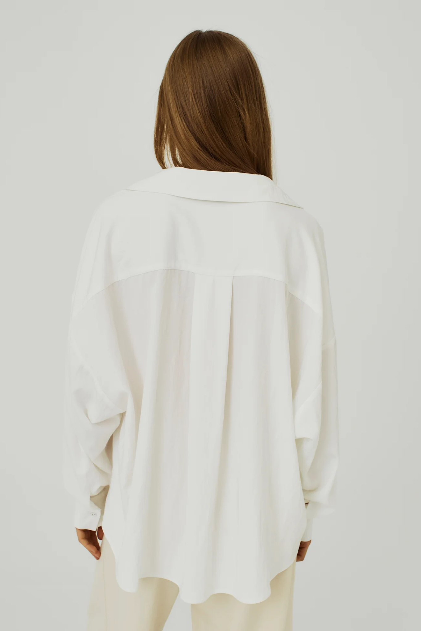 Model wearing the Norr Edona top in white. Back view