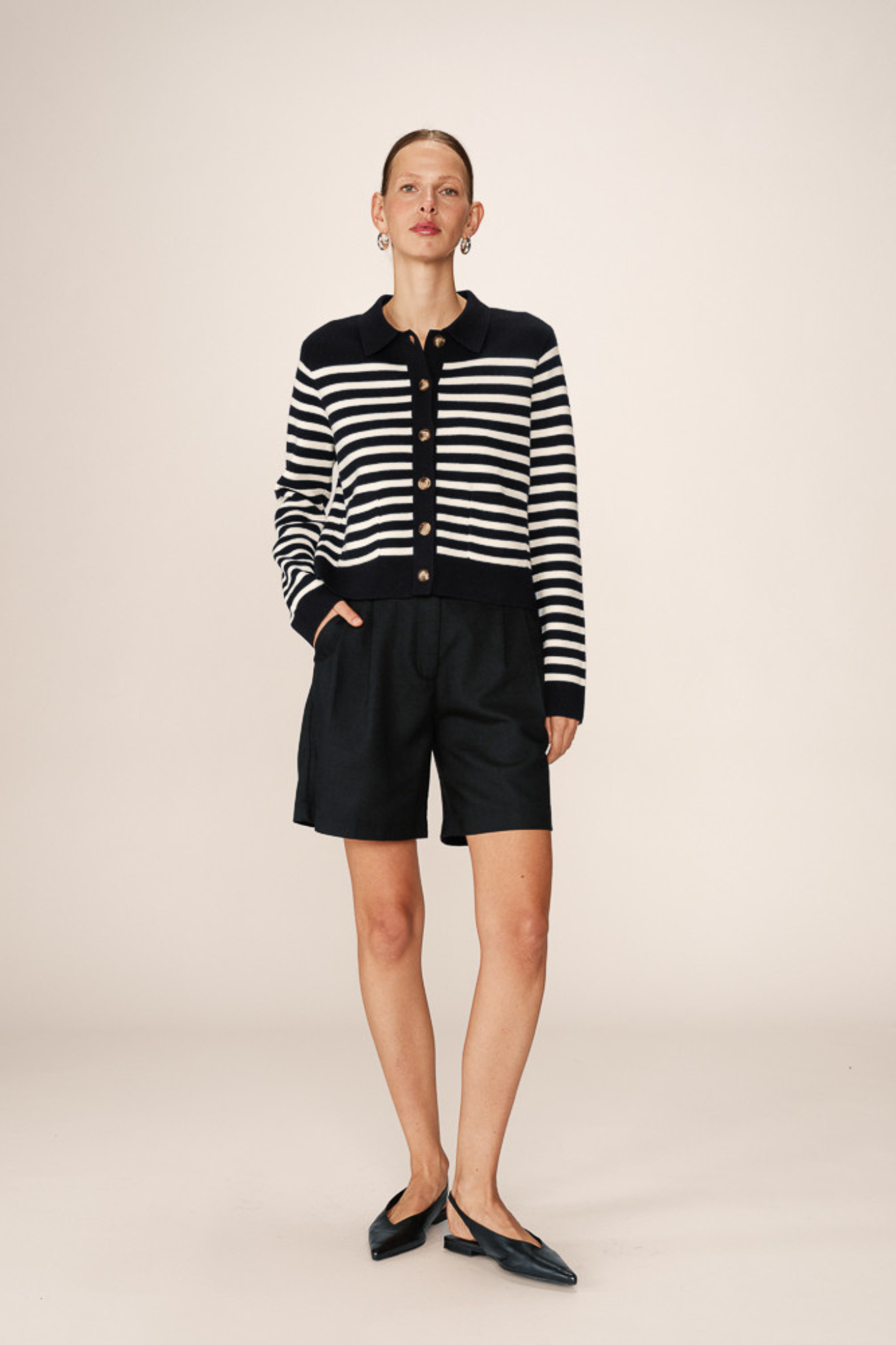 Model wearing the Grace & Mila pam cardigan in marine stripes in black and white. Front view