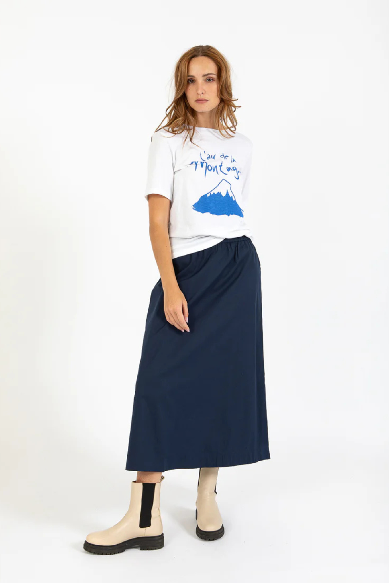 Model wearing the CC heart Phoebe long skirt in navy. Front view