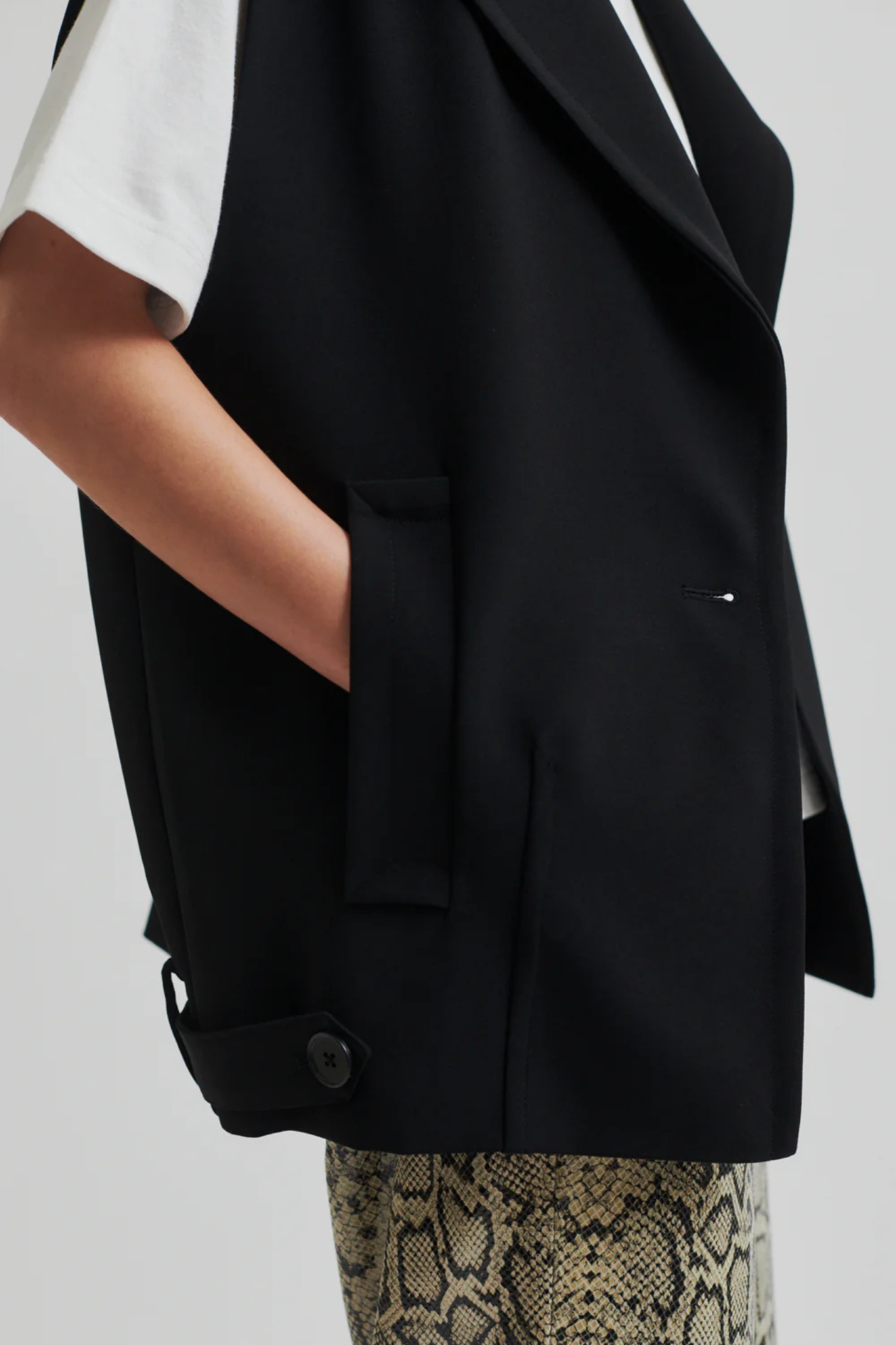 Model wearing the Second Female fique oversize waistcoat in black. Side view