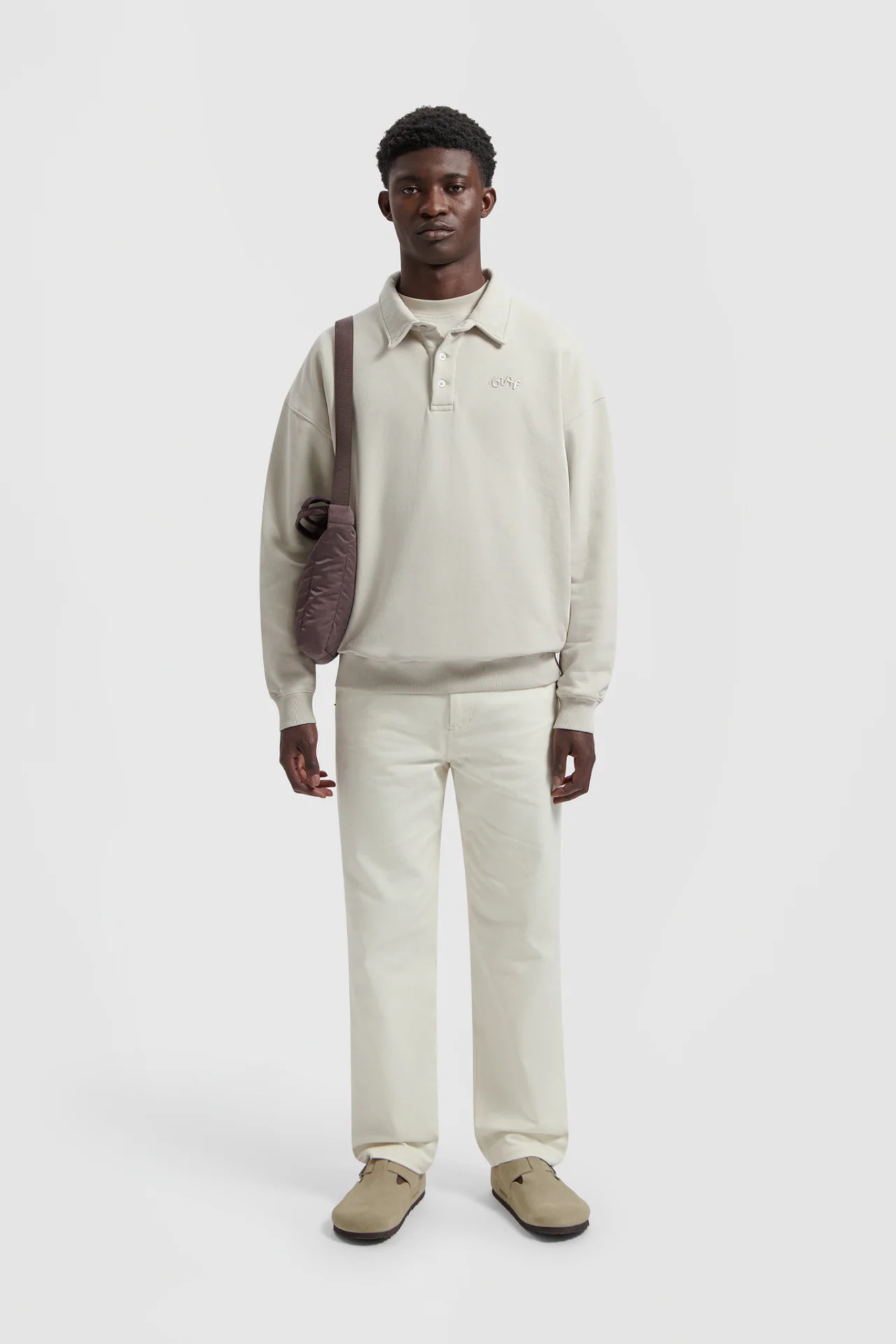 Model wearing the Olaf workwear pants in off-white. Front view