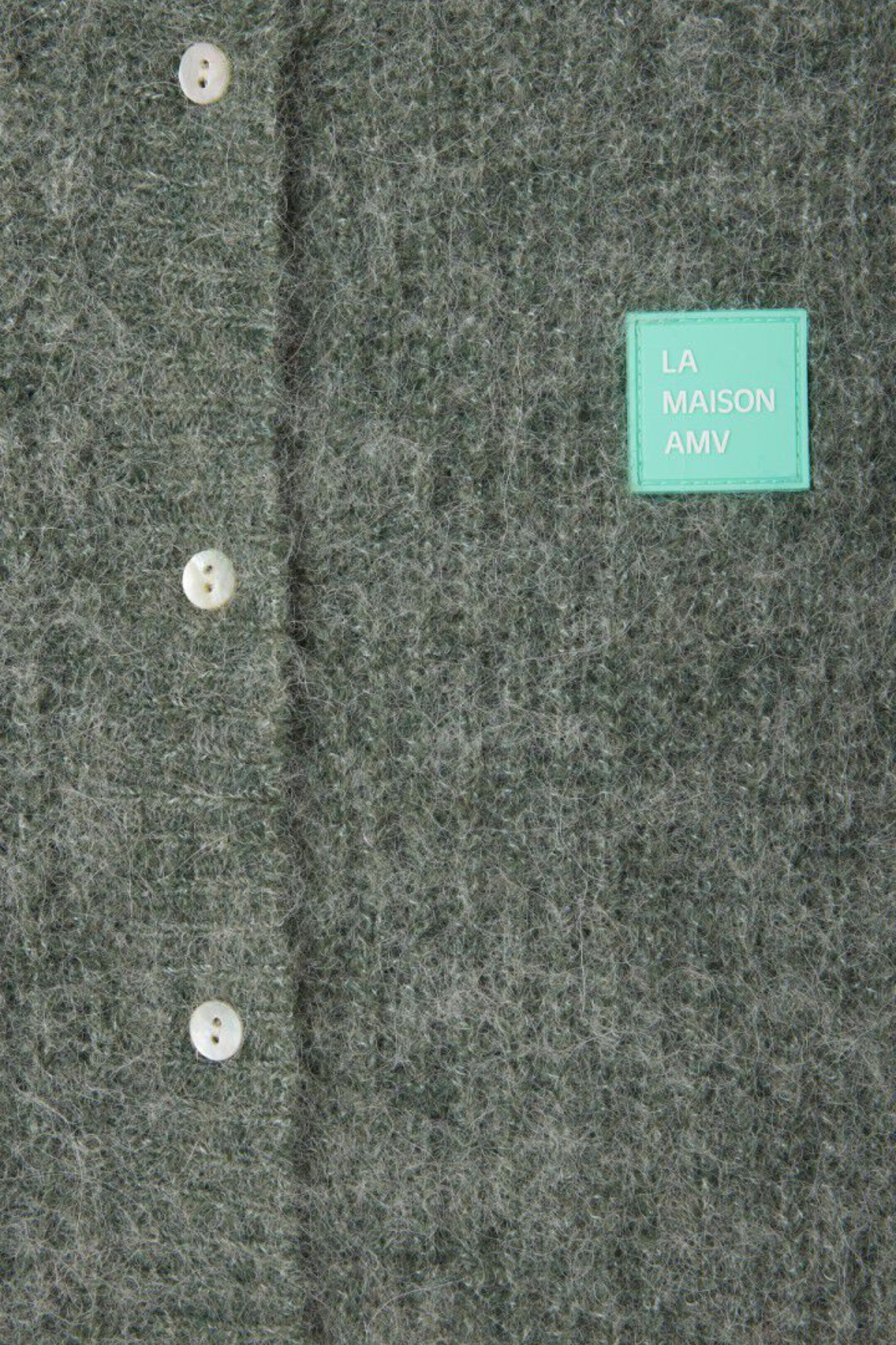 American Vintage green sleeveless cardigan with logo in blue. Close front view