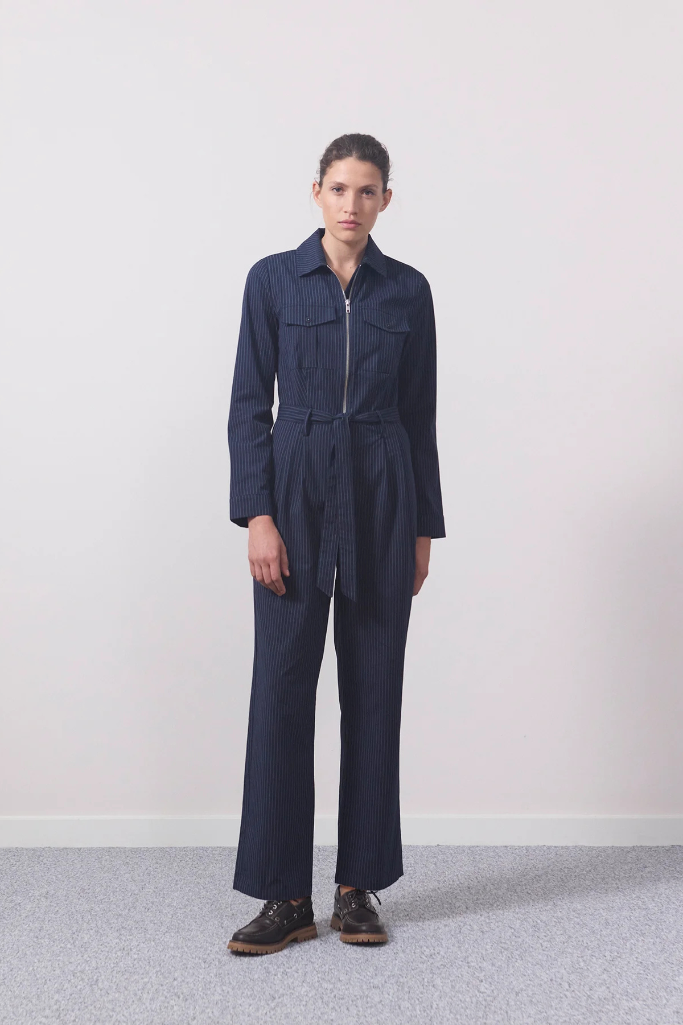 Model wearing the Modstrom mathilde jumpsuit in navy sky. Front view