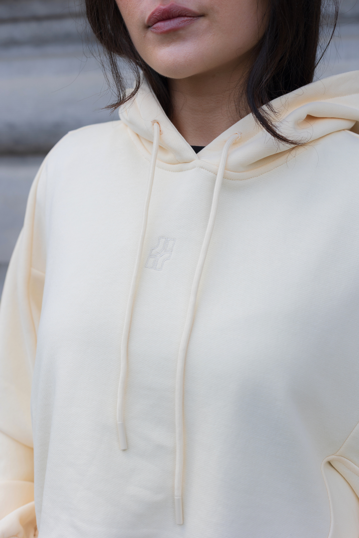 Model wearing the JIJI STUDIOS cathy sweatshirt in creme / yellow. Close front view