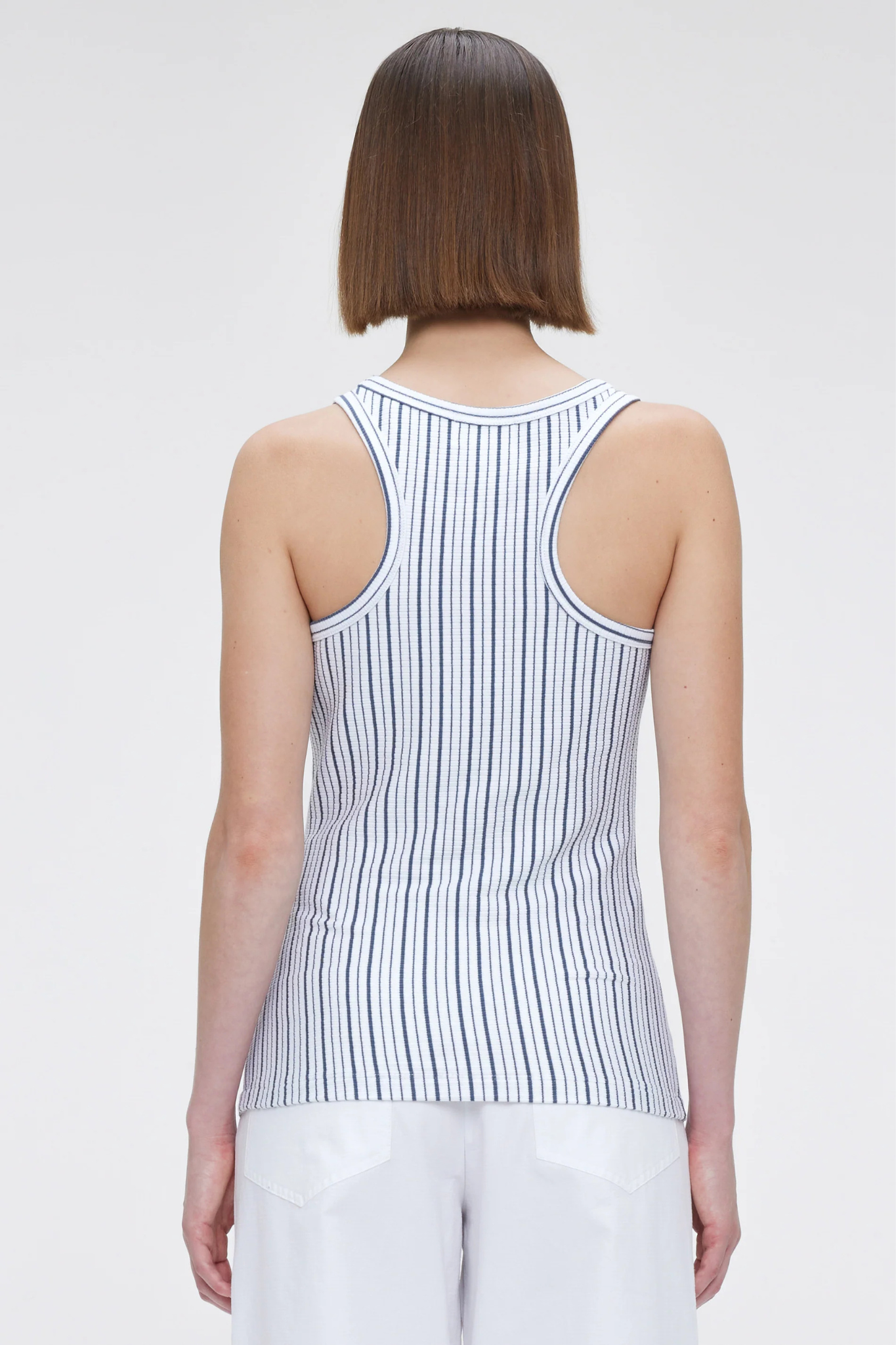 Model wearing the Our Sister kami top in white. Back view