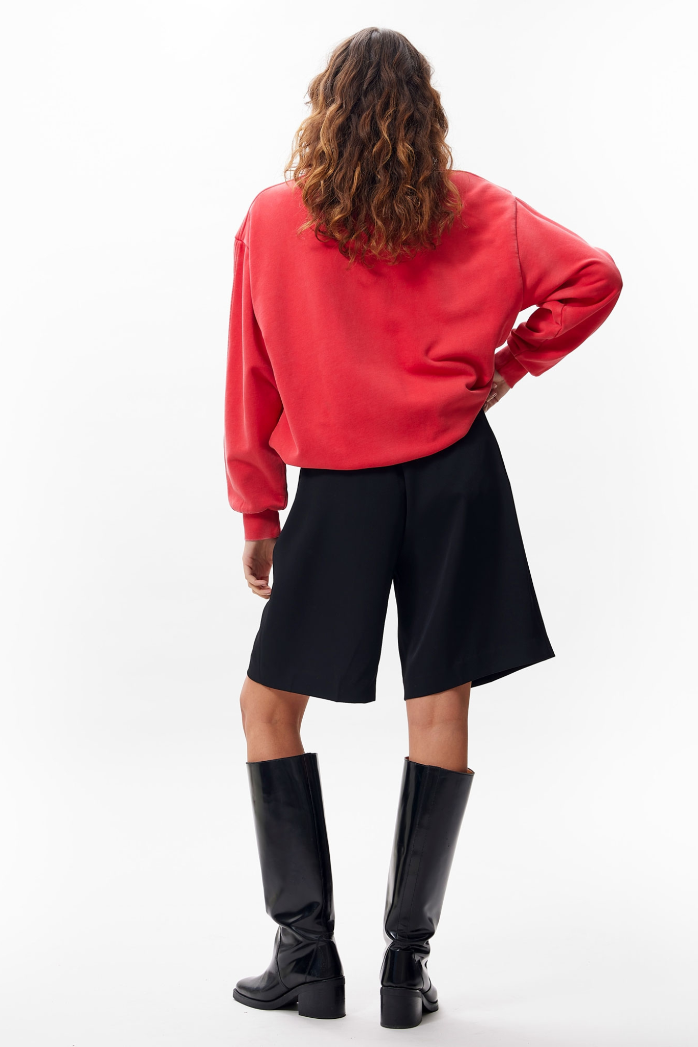 Model wearing the Catwalk Junkie oversized tuck in sweater in toreador red. Back view