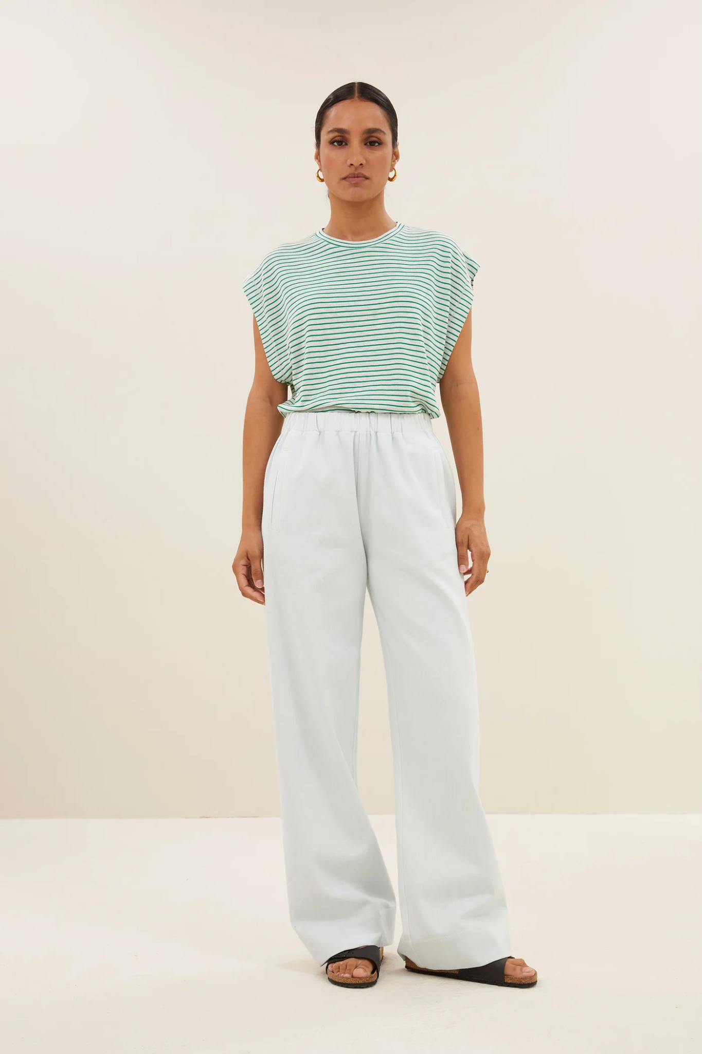 Model wearing the By-Bar mason small stripe top in white and green striped. Front view