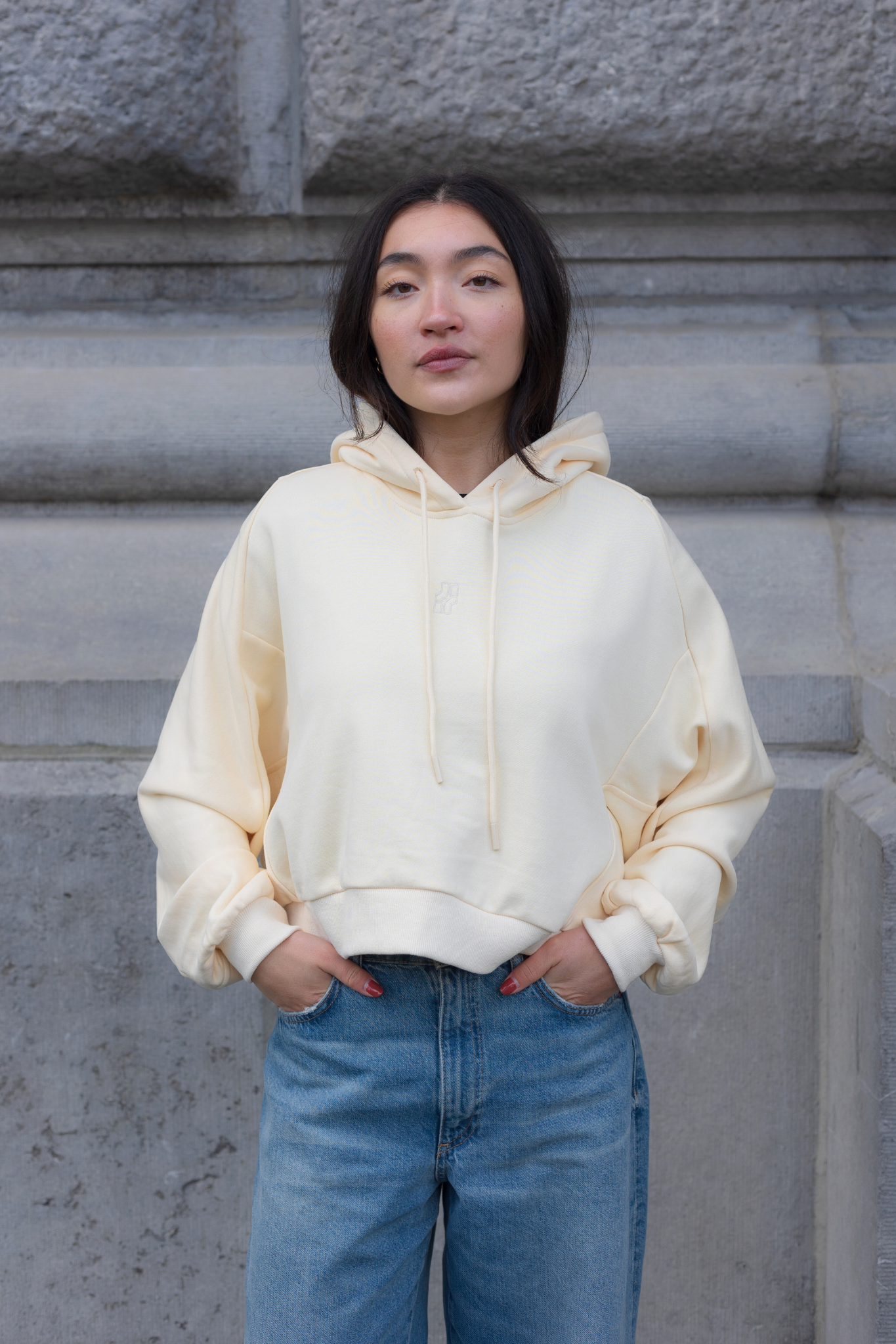 Model wearing the JIJI STUDIOS cathy sweatshirt in creme / yellow. Front view