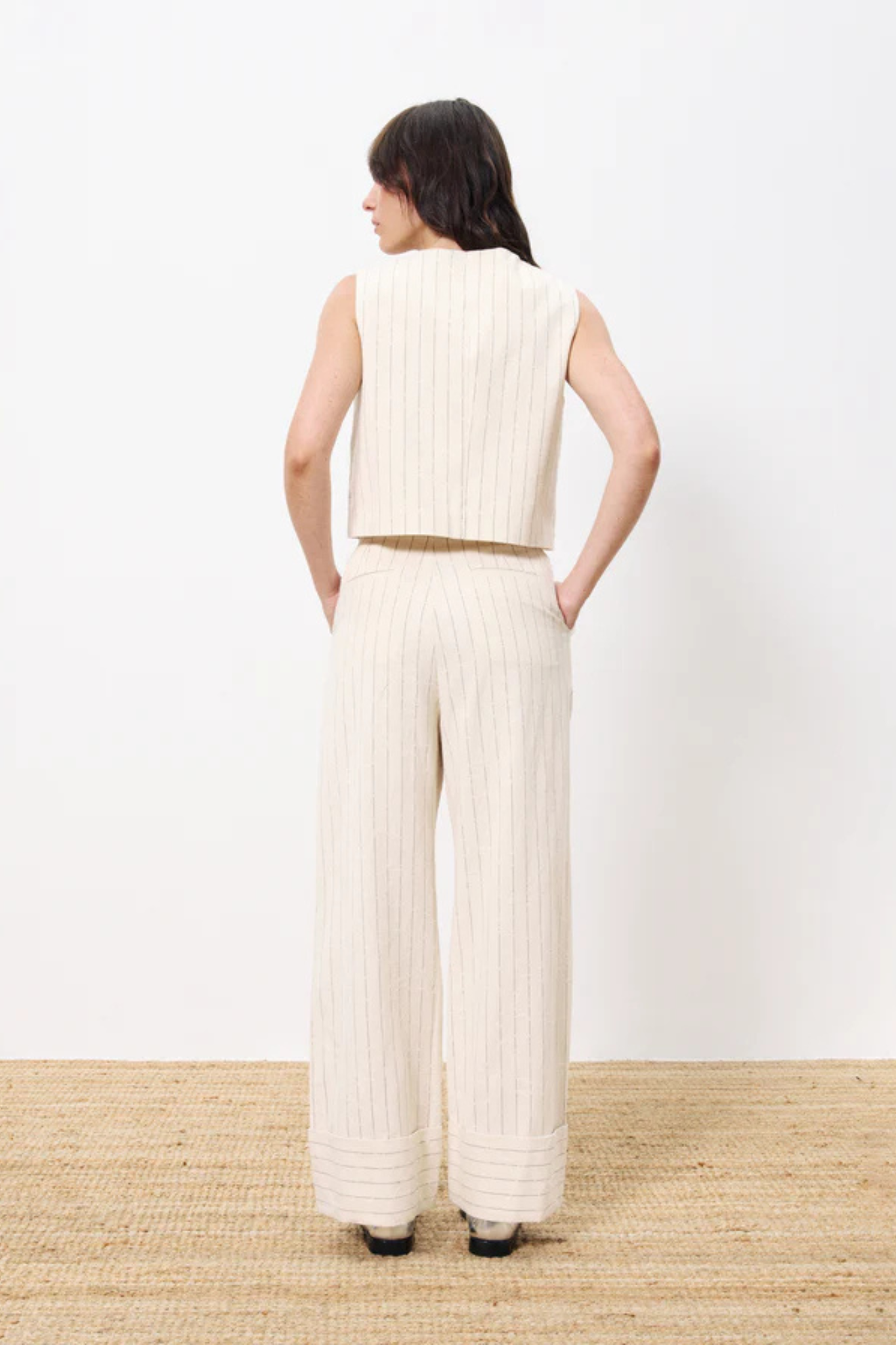 Model wearing the FRNCH ersilia suit vest striped in creme. Back view