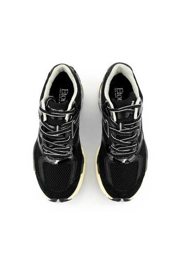 Etonic evolution sneaker in black. Front view