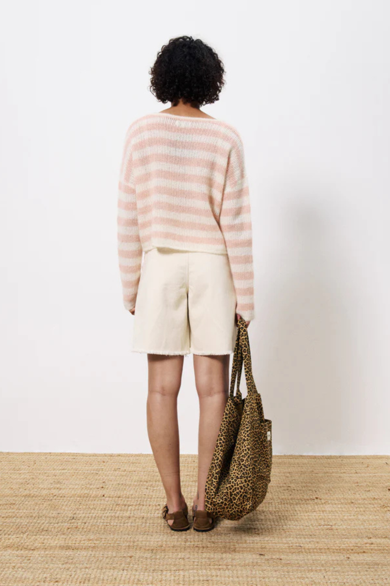 Model wearing the FRNCH norine pull in striped white and pink. Back view