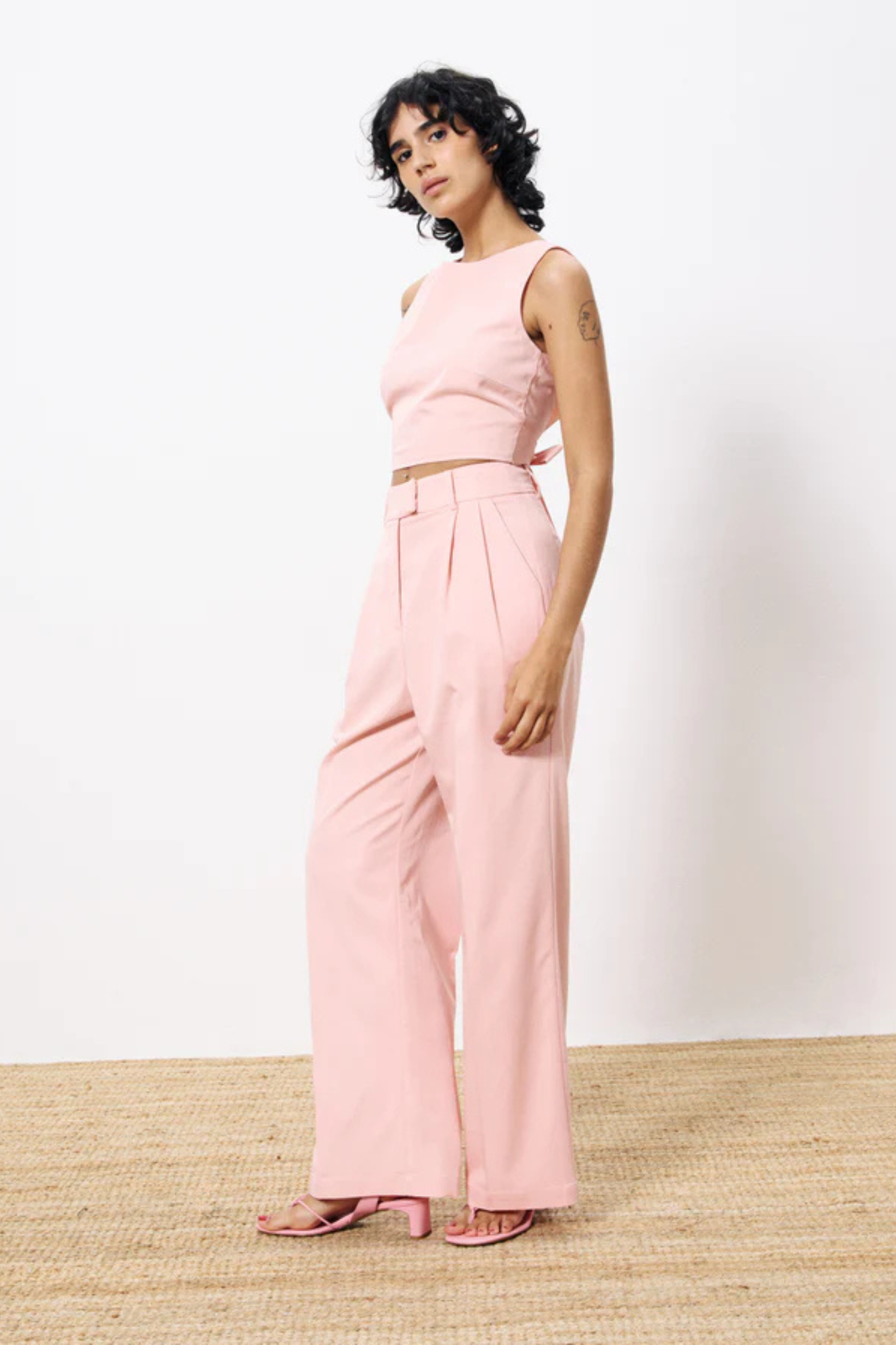 Model wearing the FRNCH adassa pants in pink. Side view