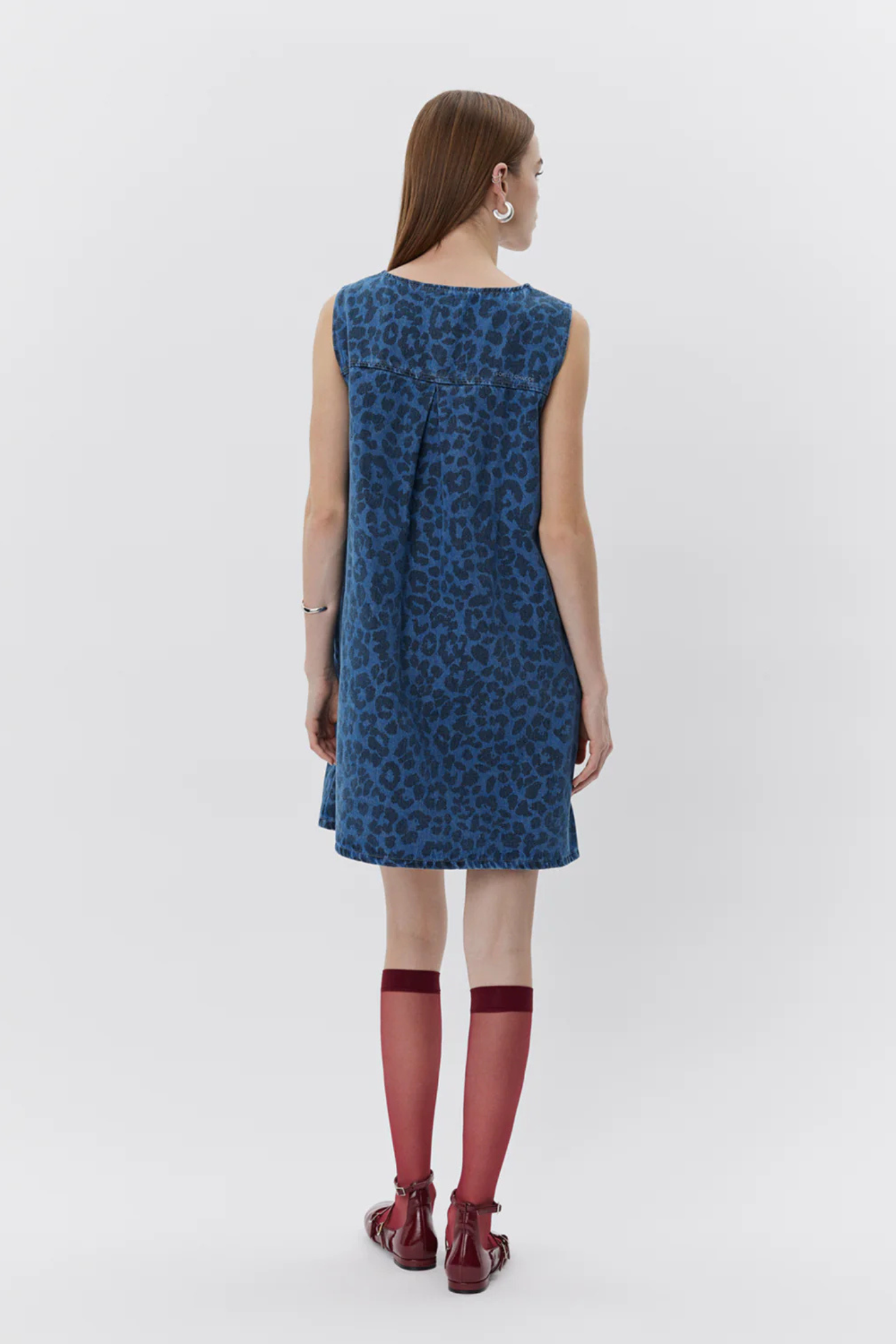 Model wearing the Sofie Schnoor ingrid dress in leopard denim blue. Back view