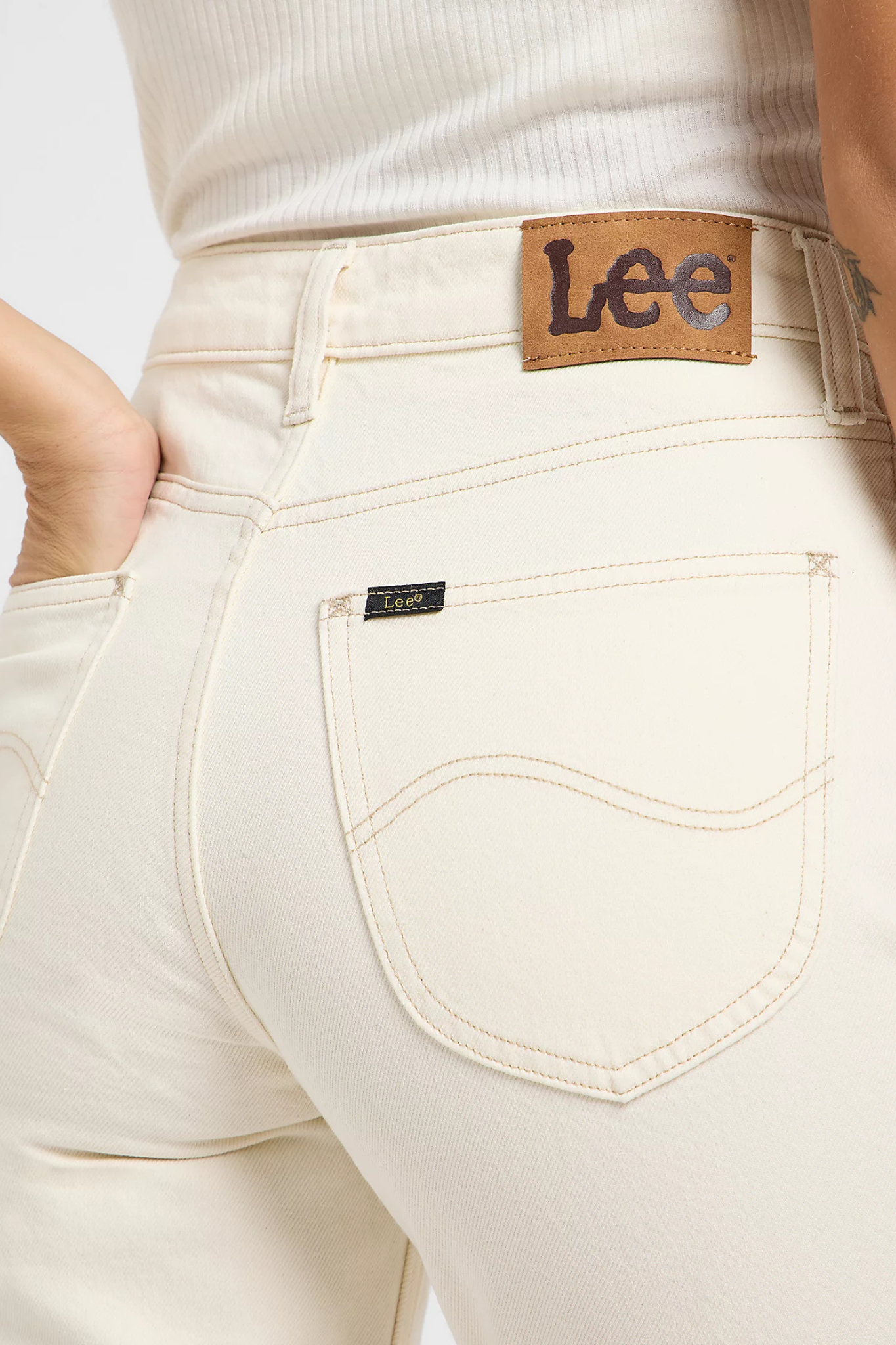 Model wearing the Lee carol jeans in off white. Close back pocket view